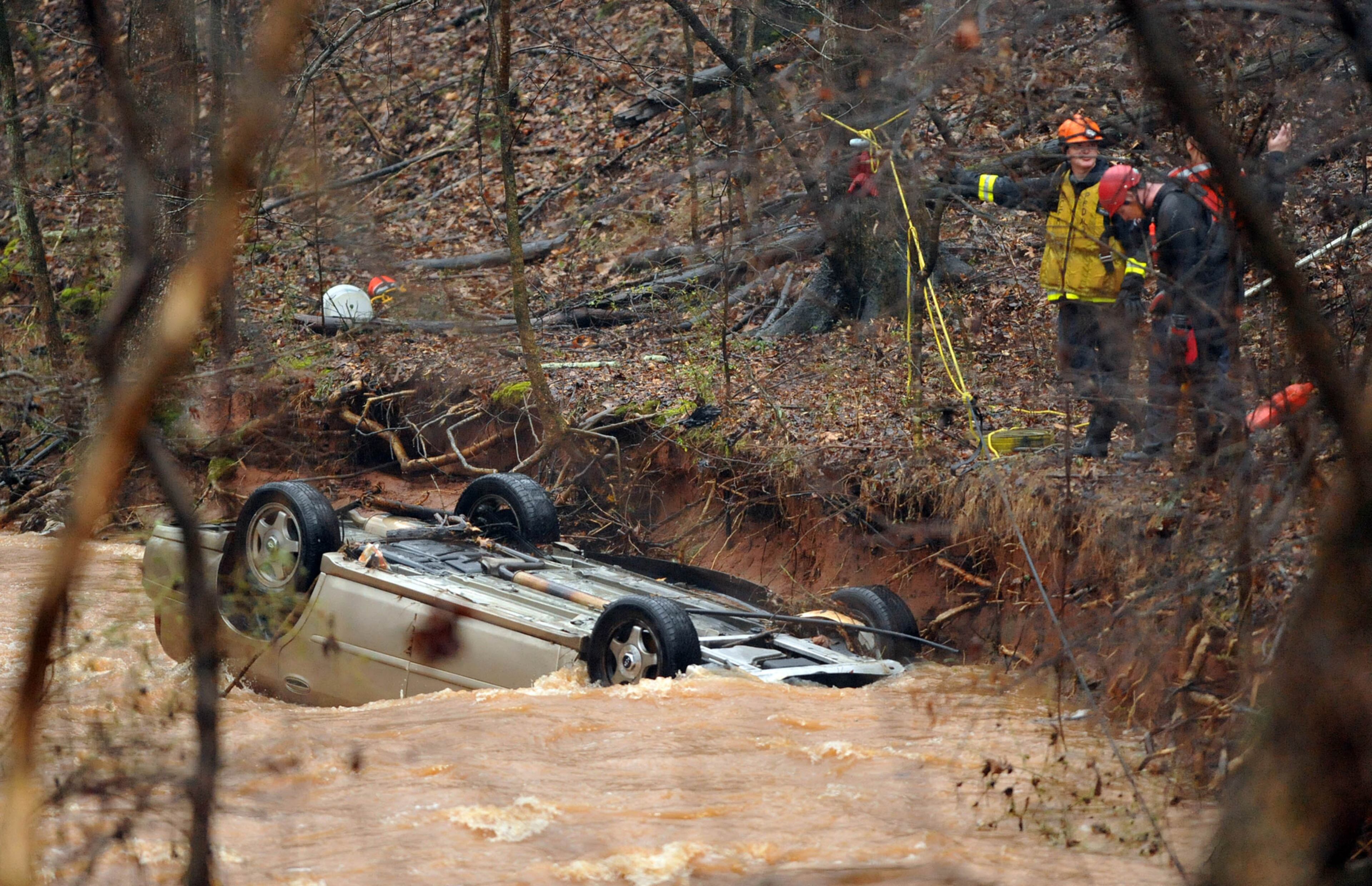 CAR IN CREEK--FEBRUARY 3, 2016 DECATUR DeKalb County Fire Rescue firefighters performed a swift water rescue after a motorist left the roadway and ended up in Fowler Branch Wednesday, February 3, 2016. DCFR Capt. Eric Jackson said the southbound vehicle left the roadway and was swept into the swift moving waters of the creek, swollen by early morning rains. "By the time the vehicle got approximately 300 feet down the stream, the car overturned with someone in it," Jackson said. "That person either got out or was pushed out and went downstream another 150 to 200 yards where they landed on a creek bed." Jackson said about 8 firefighters performed a swift water rescue of the female occupant and brought her to safety. She was the lone occupant of the vehicle and was taken to a local hospital for observation. KENT D. JOHNSON/ kdjohnson@ajc.com