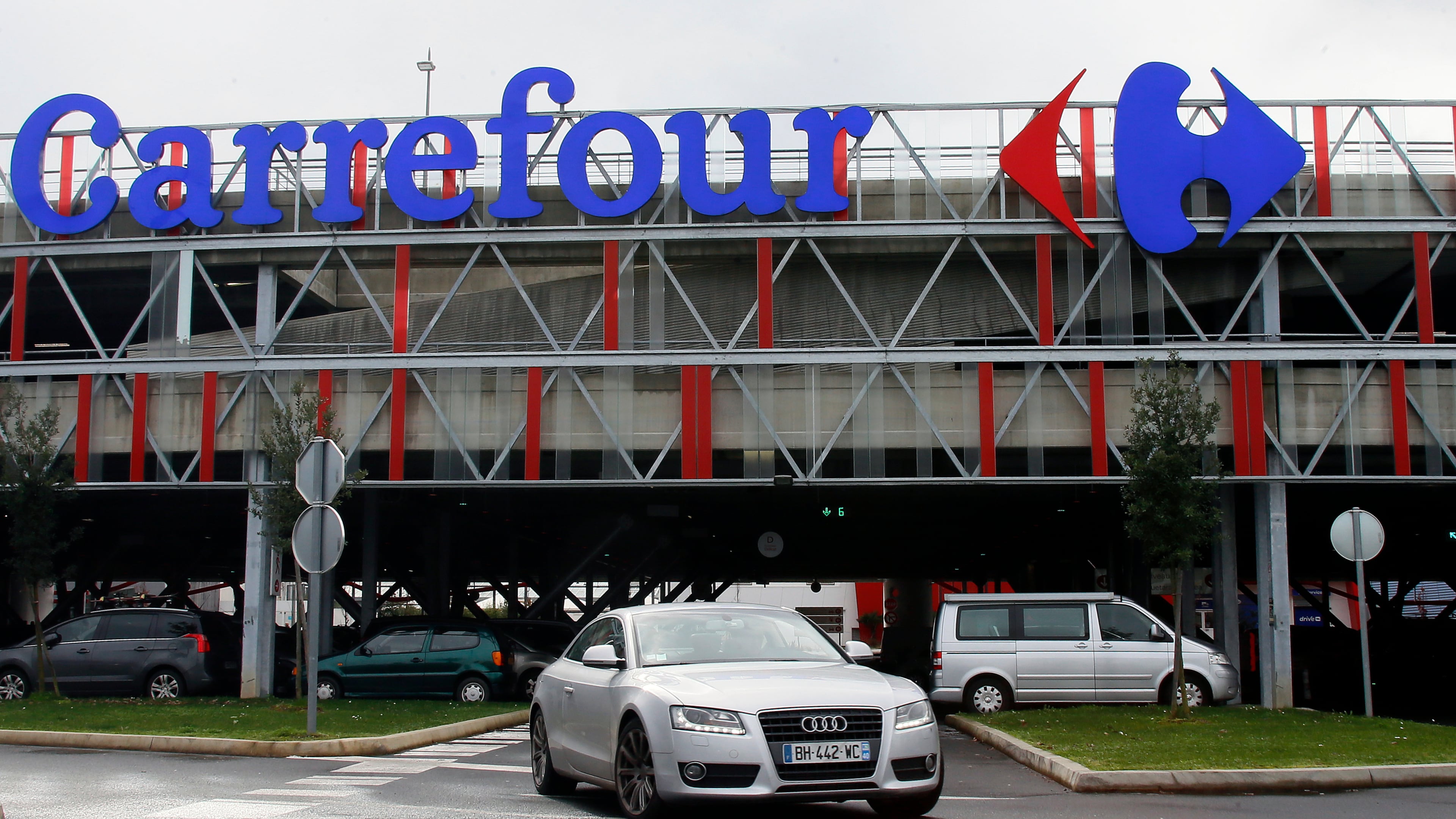 FILE - A car leaves a Carrefour supermarket in Anglet, southwestern France, on Jan. 23, 2018. (AP Photo/Bob Edme, File)