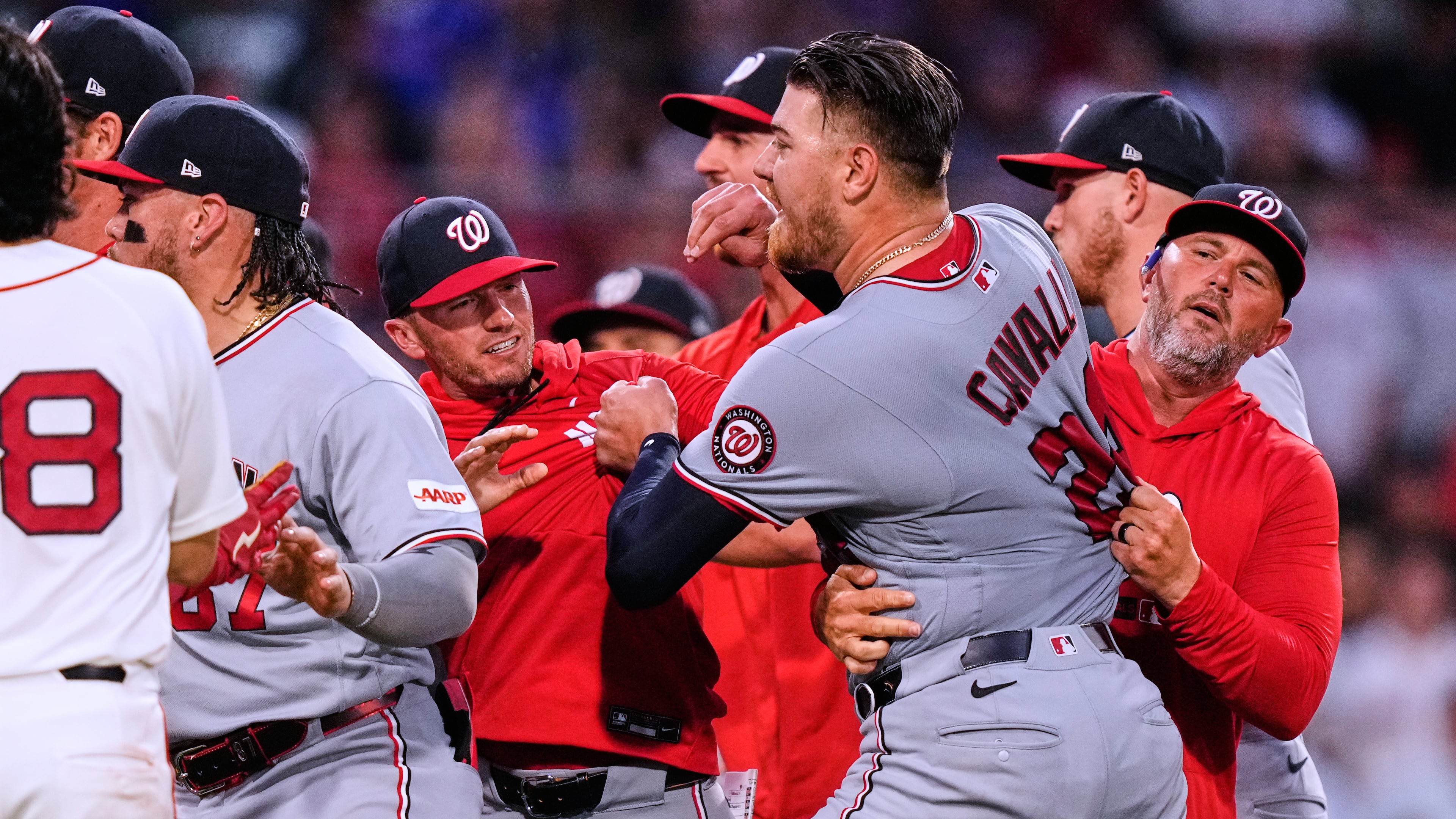 Washington Nationals' Cade Cavalli, front right, is held back as tempers flare during the fourth inning of a baseball game against the Boston Red Sox, Tuesday, June 30, 2026, in Boston. (AP Photo/Charles Krupa)