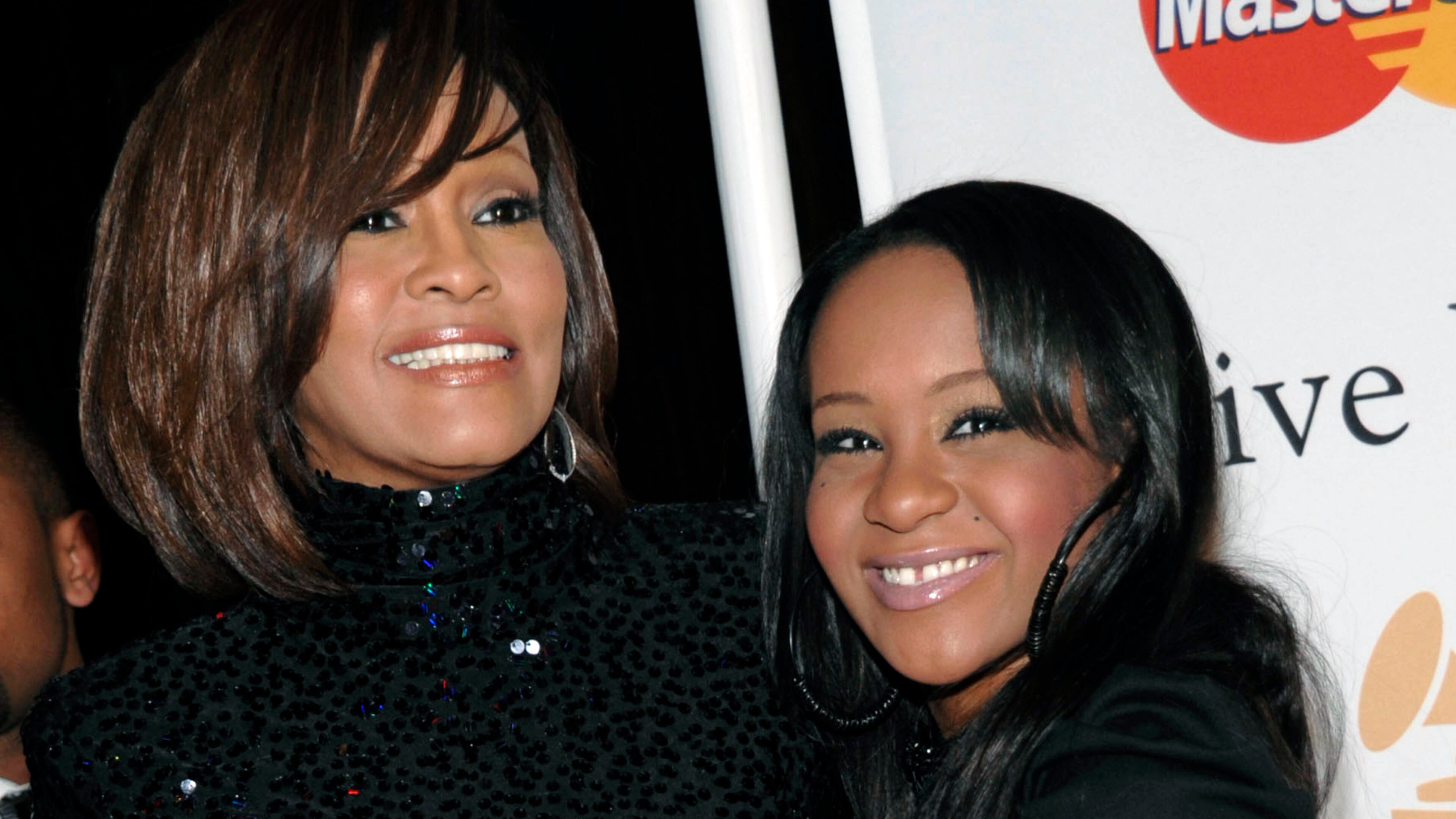 In this Feb. 12, 2011, file photo, singer Whitney Houston, left, and daughter Bobbi Kristina Brown arrive at an event in Beverly Hills, Calif. Brown, who was in hospice after months of receiving medical care, died on July 26, 2015.