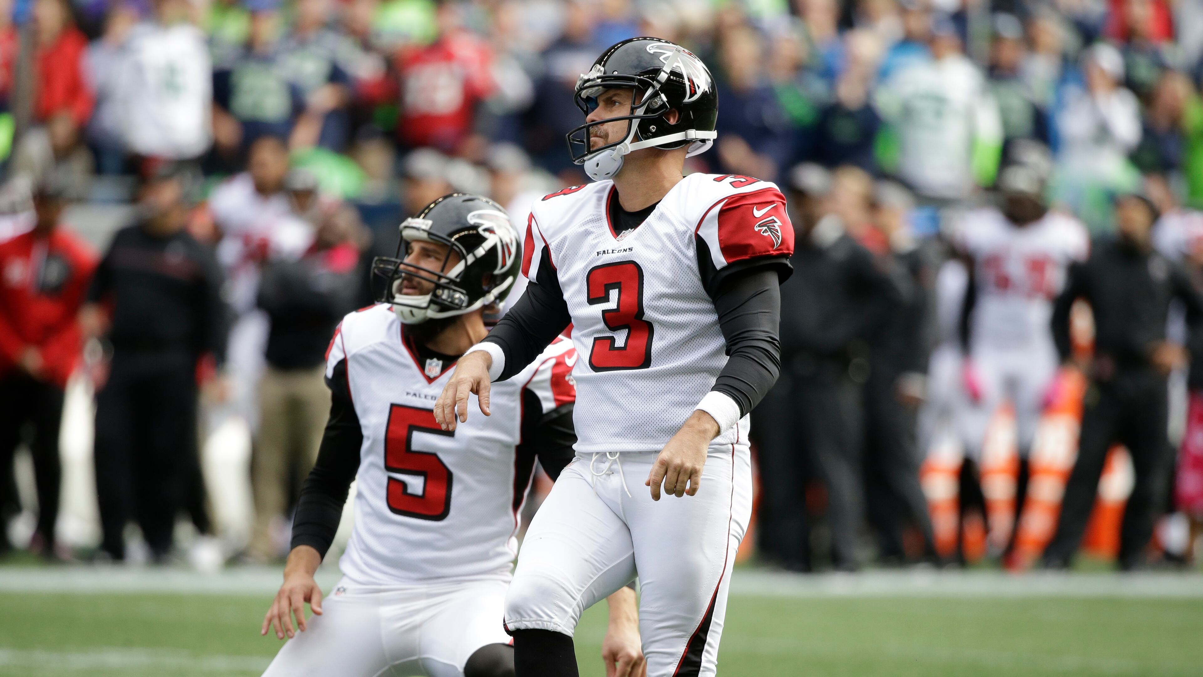 Atlanta Falcons kicker Matt Bryant, right, watches after he kicked a field goal with punter Matt Bosher (5) holding, in the first half of an NFL football game, Sunday, Oct. 16, 2016, in Seattle. (AP Photo/Elaine Thompson)