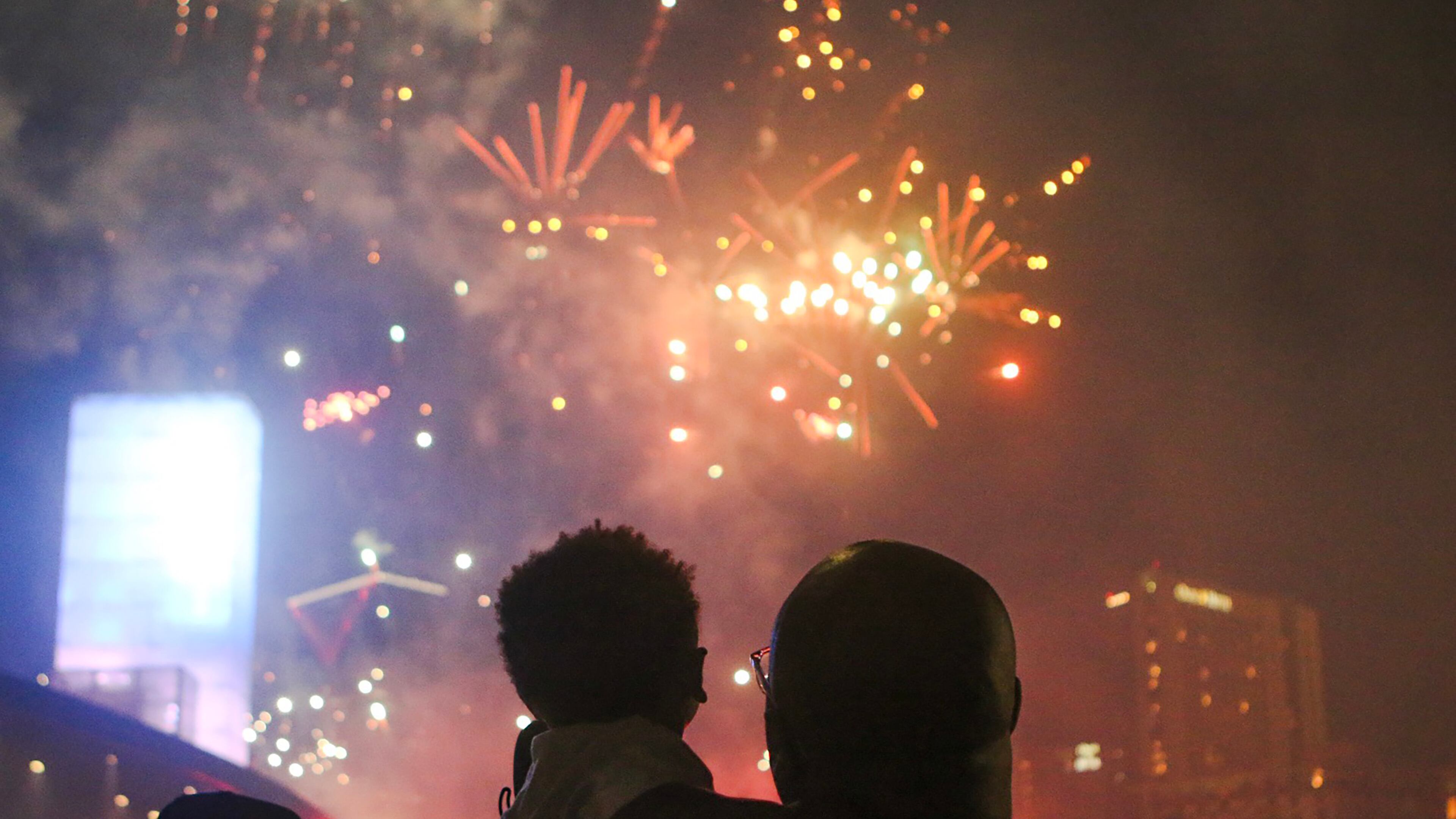 A man holds a child while they watch fireworks at Centennial Olympic Park in Atlanta on Thursday, July 4, 2019. The fireworks show, part of the annual Fourth of July celebration, was sponsored by the Georgia World Congress Center Authority and Coca-Cola. Christina Matacotta/Christina.Matacotta@ajc.com