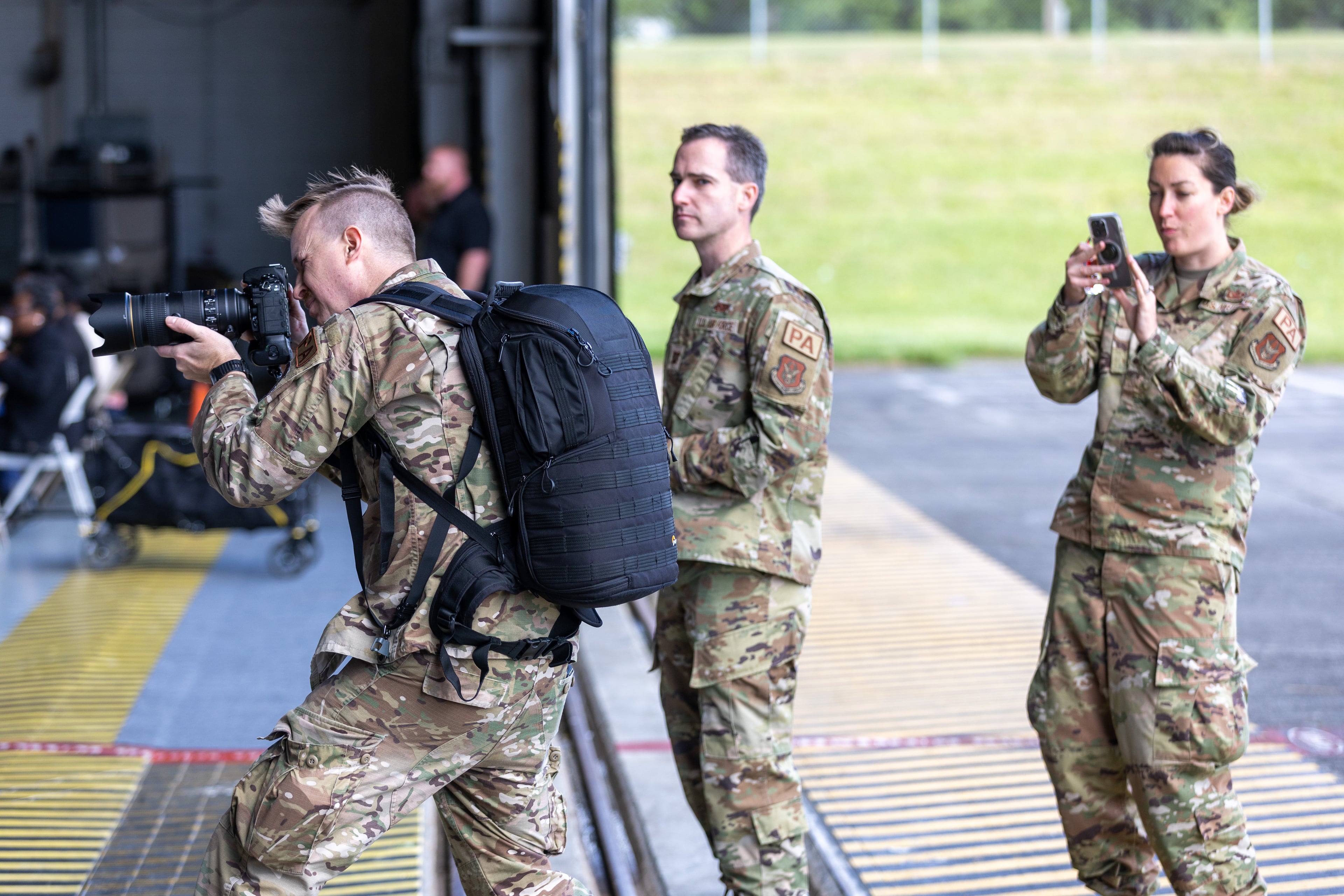 Staff Sgt. Matthew Matlock (Left) takes a photograph of U.S. Sen. Jon Ossoff as he speaks to the crowd during the Military Service Academy Day at Dobbins Air Reserve Base in Marietta on Saturday, April 22, 2023. (Steve Schaefer/steve.schaefer@ajc.com)