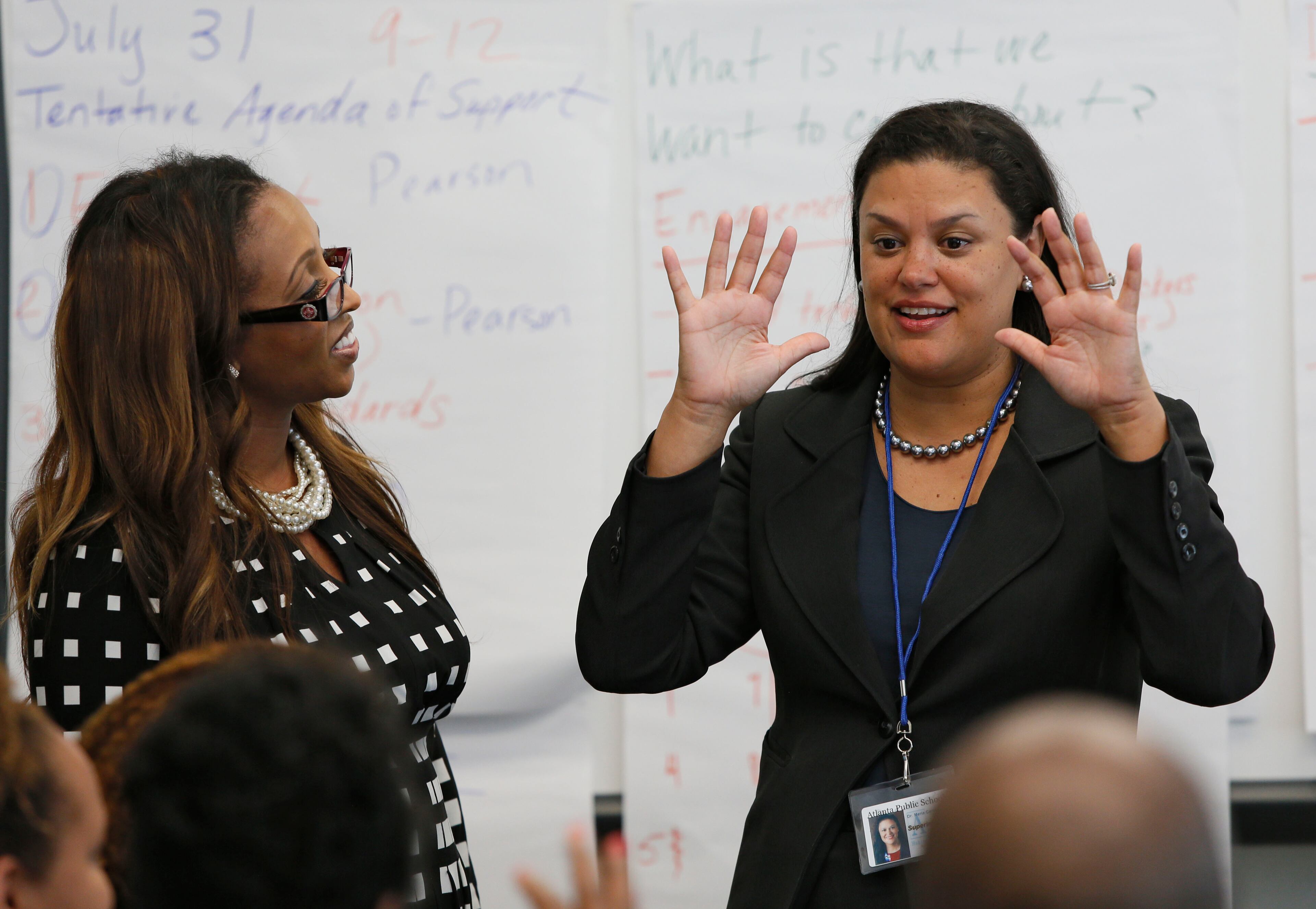 July 7, 2014 - Atlanta - Meria Carstarphen (right) and principal Shelly Powell (left) met briefly with the summer planning team at Daniel McLaughlin Therrell High School. The first day mood was jovial. Monday was new Atlanta Public Superintendent Meria Carstarphen’s first official day on the job, which started with a staff meeting at APS offices and included a visit to Daniel McLaughlin Therrell High School. BOB ANDRES / BANDRES@AJC.COM