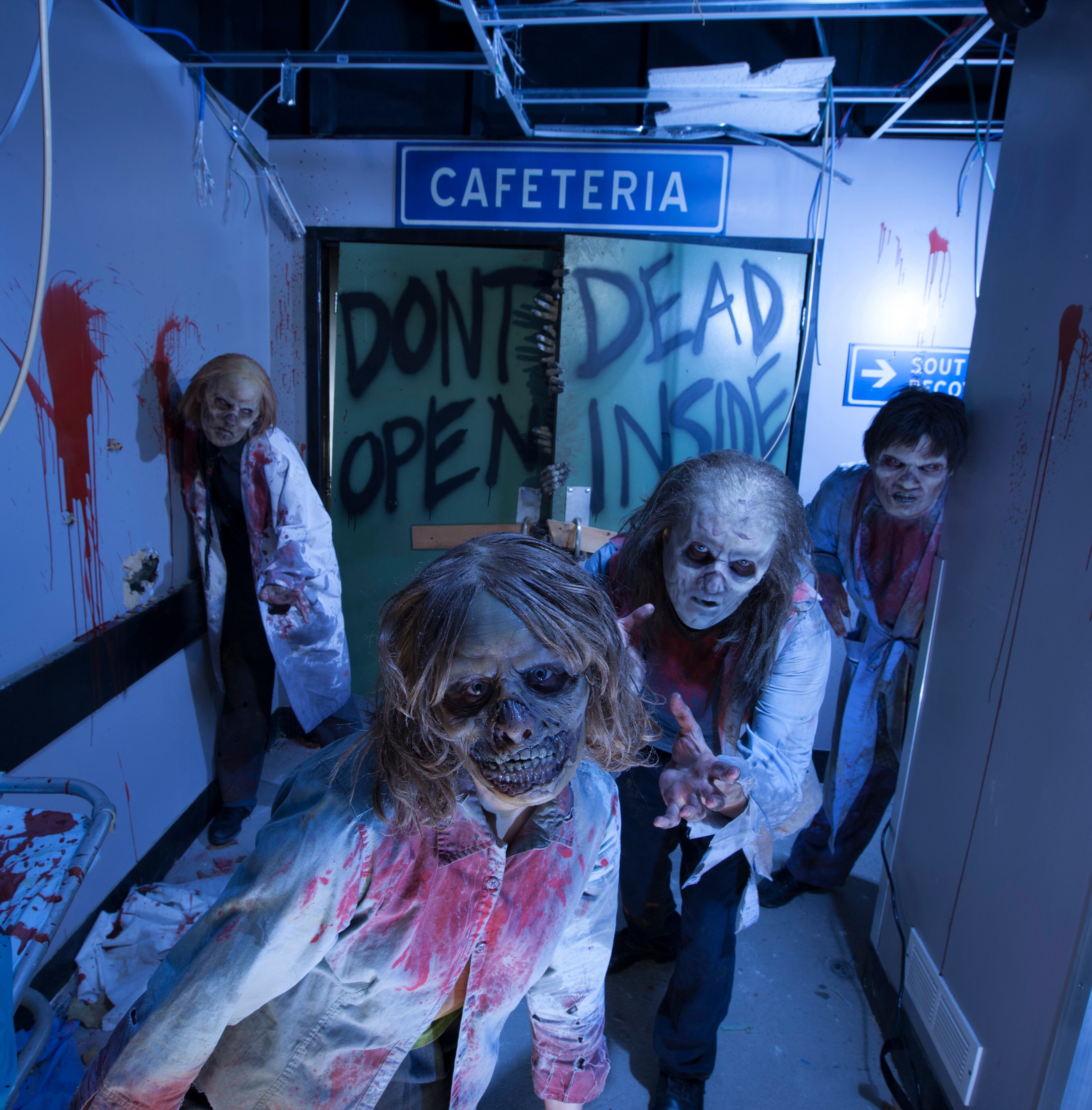 Actors portraying zombies get in the spirit of things at "The Walking Dead" themed attraction at Universal's Halloween Horror Nights in Orlando, Fla.