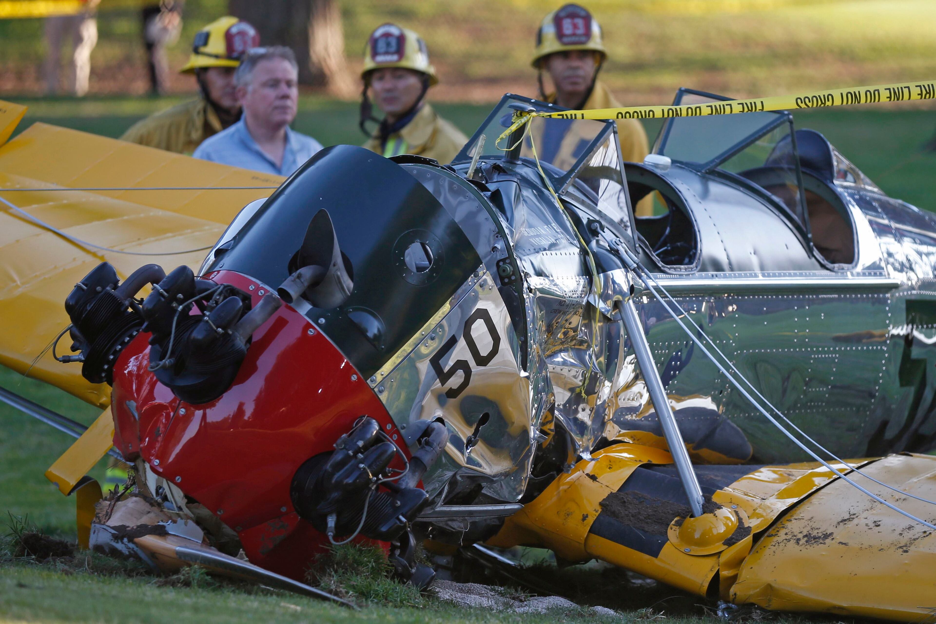 An airplane sits on the ground after crash landing at Penmar Golf Course in Venice, Los Angeles California March 5, 2015. "Star Wars" star Harrison Ford was seriously injured on Thursday when the actor crashed his vintage plane on a Los Angeles golf course shortly after taking off from a local airport, a source told Reuters. REUTERS/Lucy Nicholson