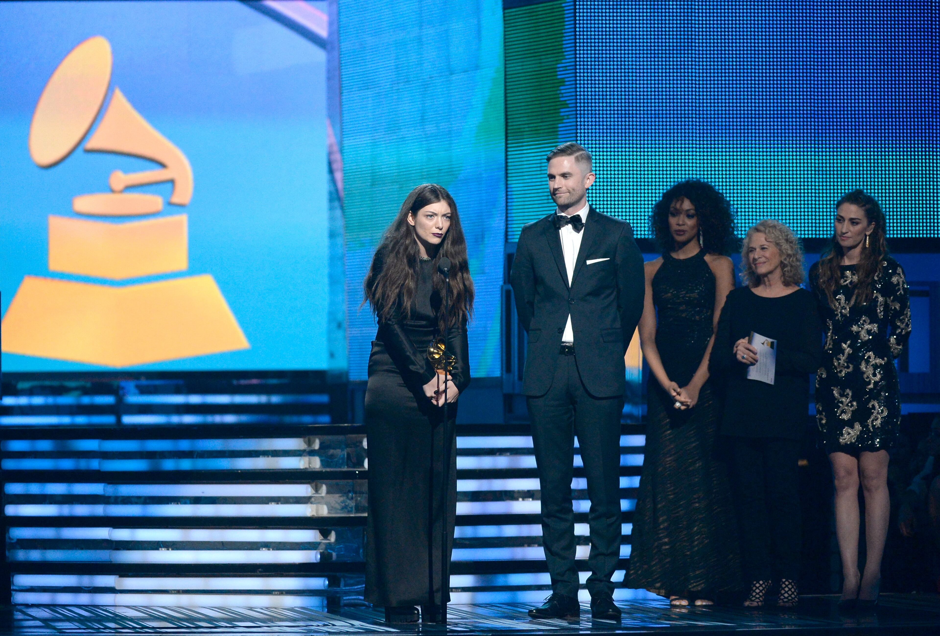 LOS ANGELES, CA - JANUARY 26: (L-R) Singer/songwriter Lorde and songwriter Joel Little accept the Song of the Year award for 'Royals' with musicians Carole King and Sara Bareilles onstage during the 56th GRAMMY Awards at Staples Center on January 26, 2014 in Los Angeles, California. (Photo by Kevork Djansezian/Getty Images)