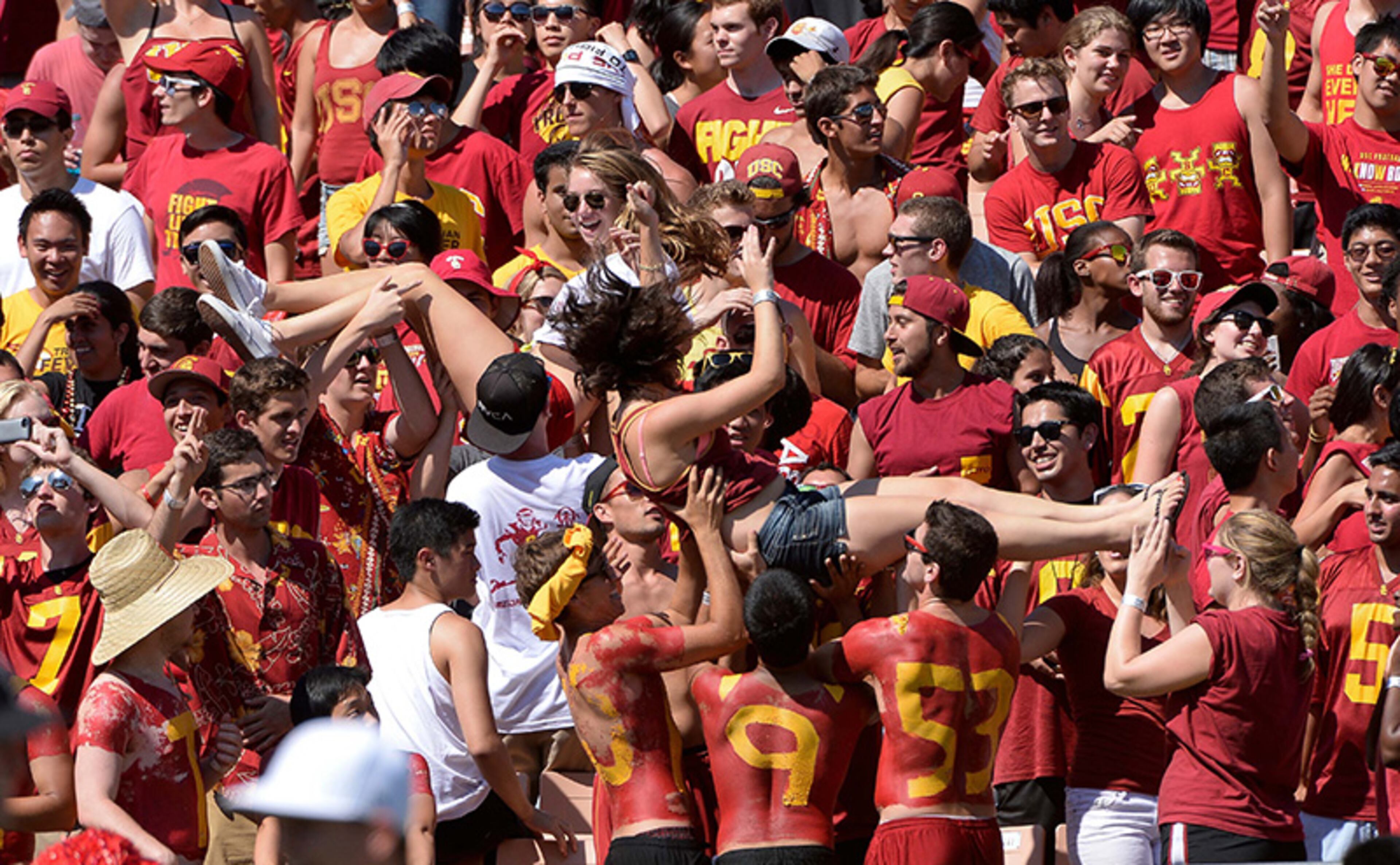 Southern Cal fans celebrate a touchdown by Justin Davis (not pictured) in the fourth quarter against the Boston College at Los Angeles Memorial Coliseum. The Trojans went on to a 35-7 win.