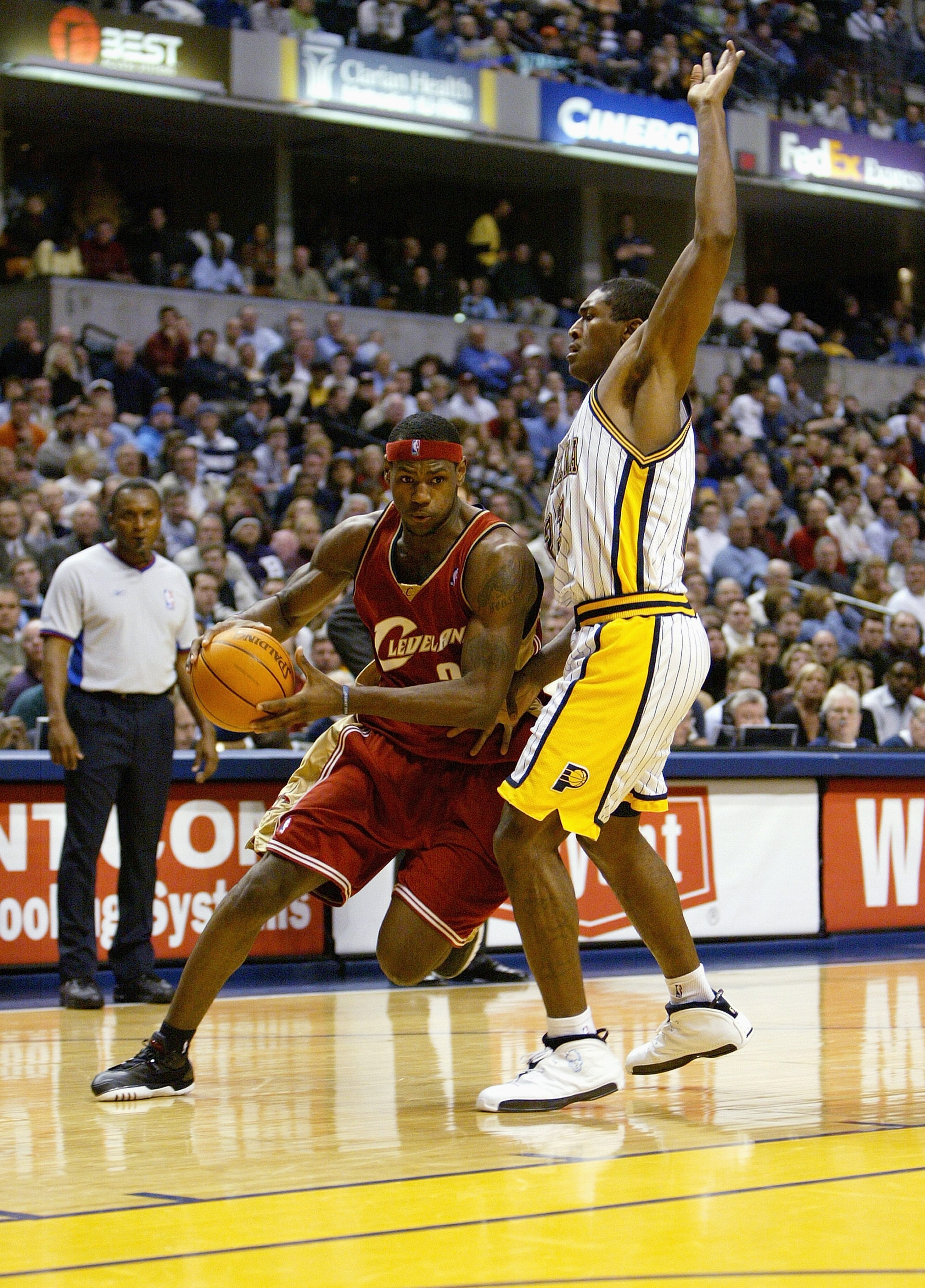 INDIANAPOLIS - DECEMBER 15: LeBron James #23 of the Cleveland Cavaliers drives as he is covered by Ron Artest #23 of the Indiana Pacers at Conseco Fieldhouse on December 15, 2003 in Indianapolis, Indiana. The Pacers won 95-85. NOTE TO USER: User expressly acknowledges and agrees that, by downloading and/or using this Photograph, User is consenting to the terms and conditions of the Getty Images License Agreement.(Photo by: Andy Lyons/Getty Images)