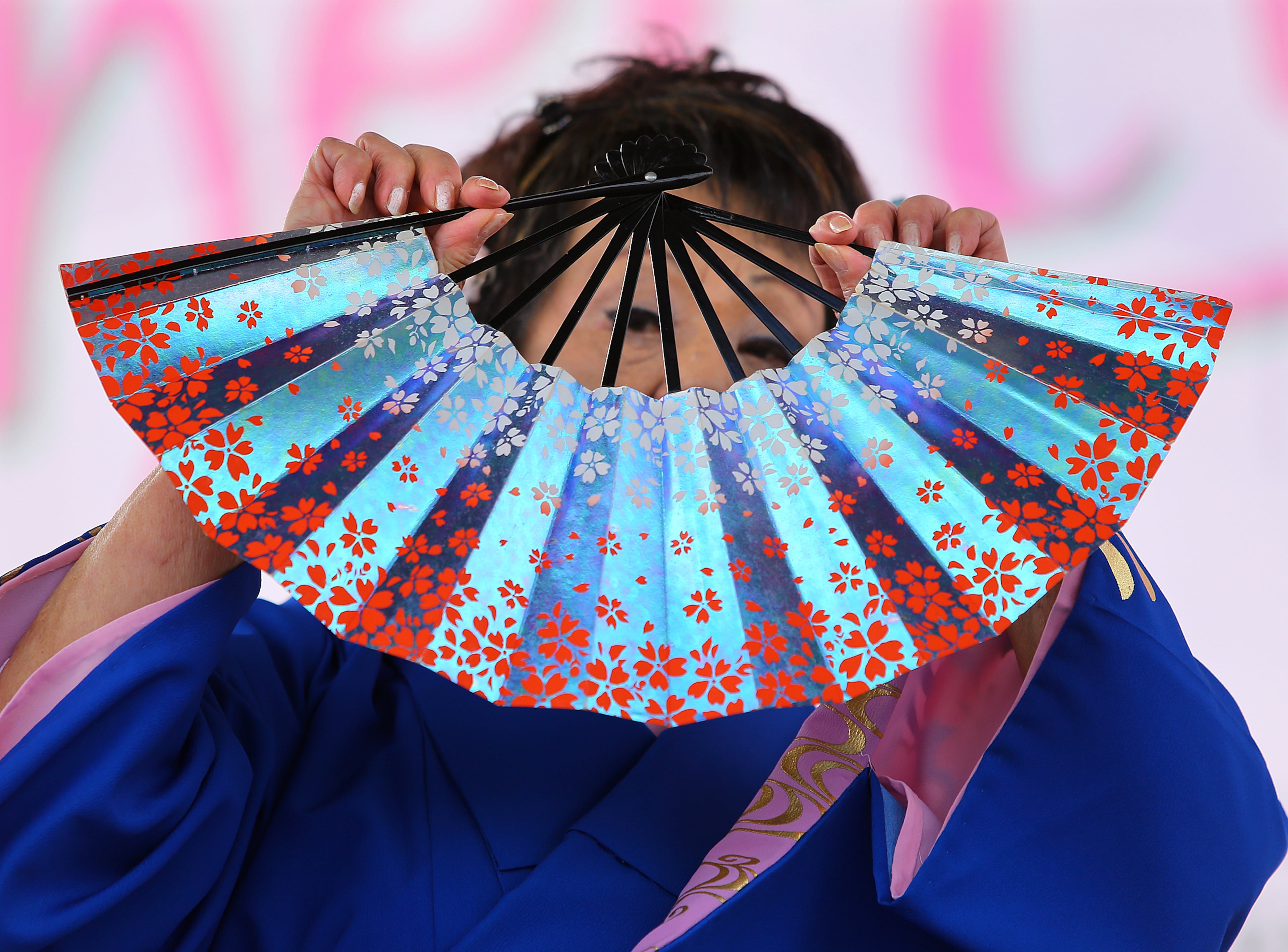 Takako Pogue, a member of the Kinuyo Shinobu Kai dance group, performs a traditional Japanese Cherry Blossum folk dance at the 33rd Annual Conyers Cherry Blossom Festival on Sunday, March 23, 2014, in Conyers.