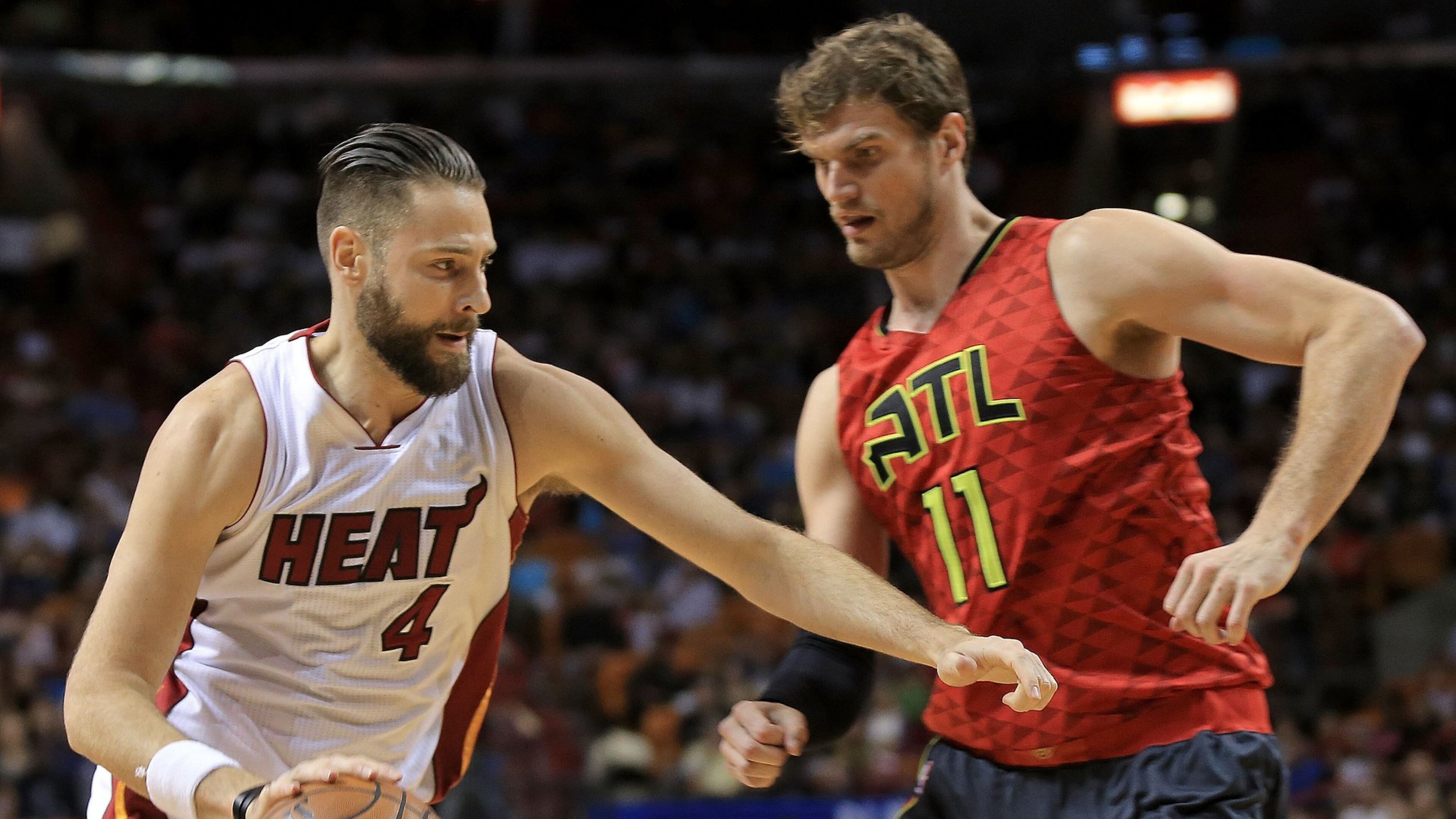 Josh McRoberts (4) of the Heat drives on Tiago Splitter (11)of the Hawks during a game last season. (Photo by Mike Ehrmann/Getty Images)