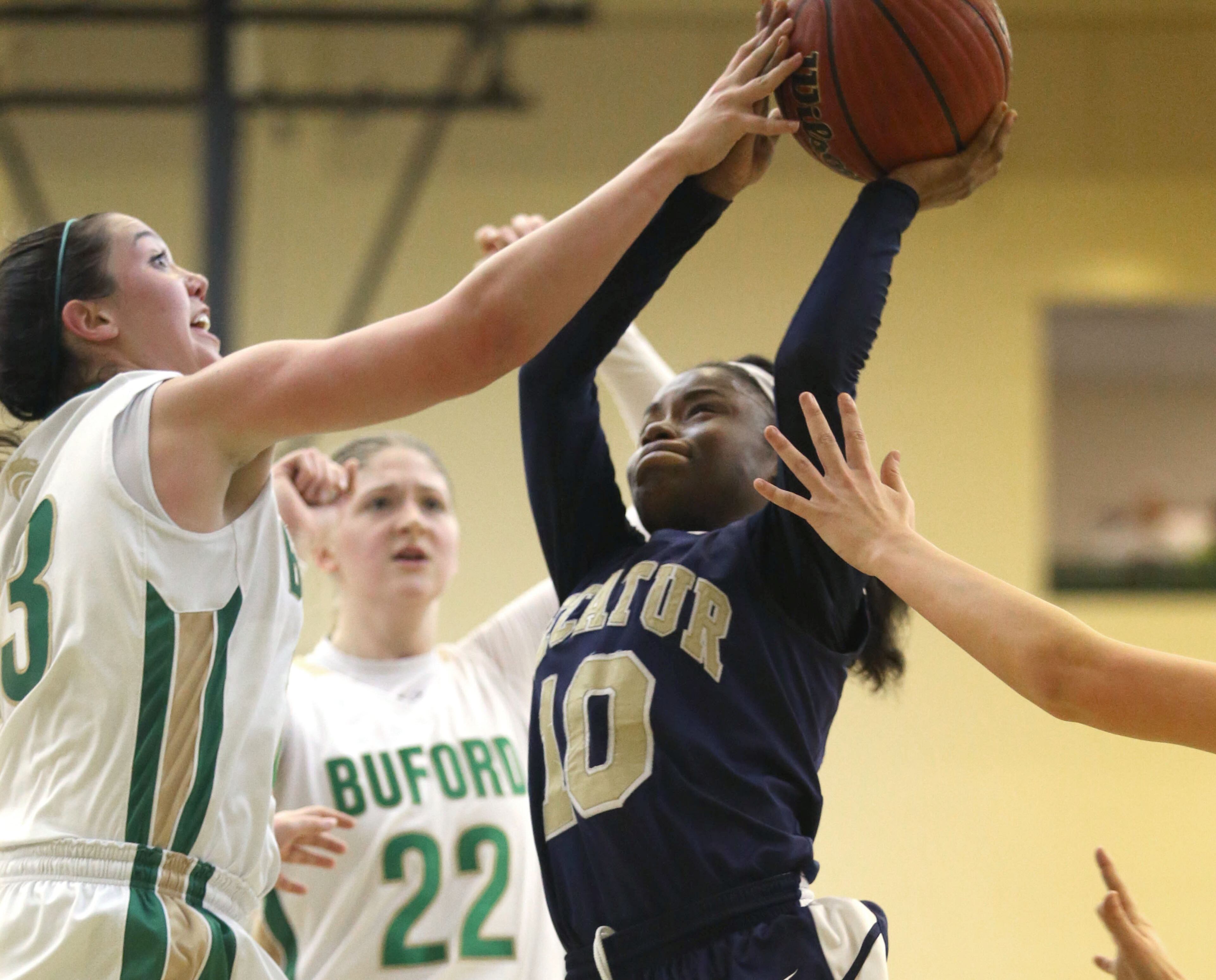 Buford's Chandler Hall, left, blocks a shot from Decatur's Jahmee Reeves (10). JASON GETZ / SPECIAL