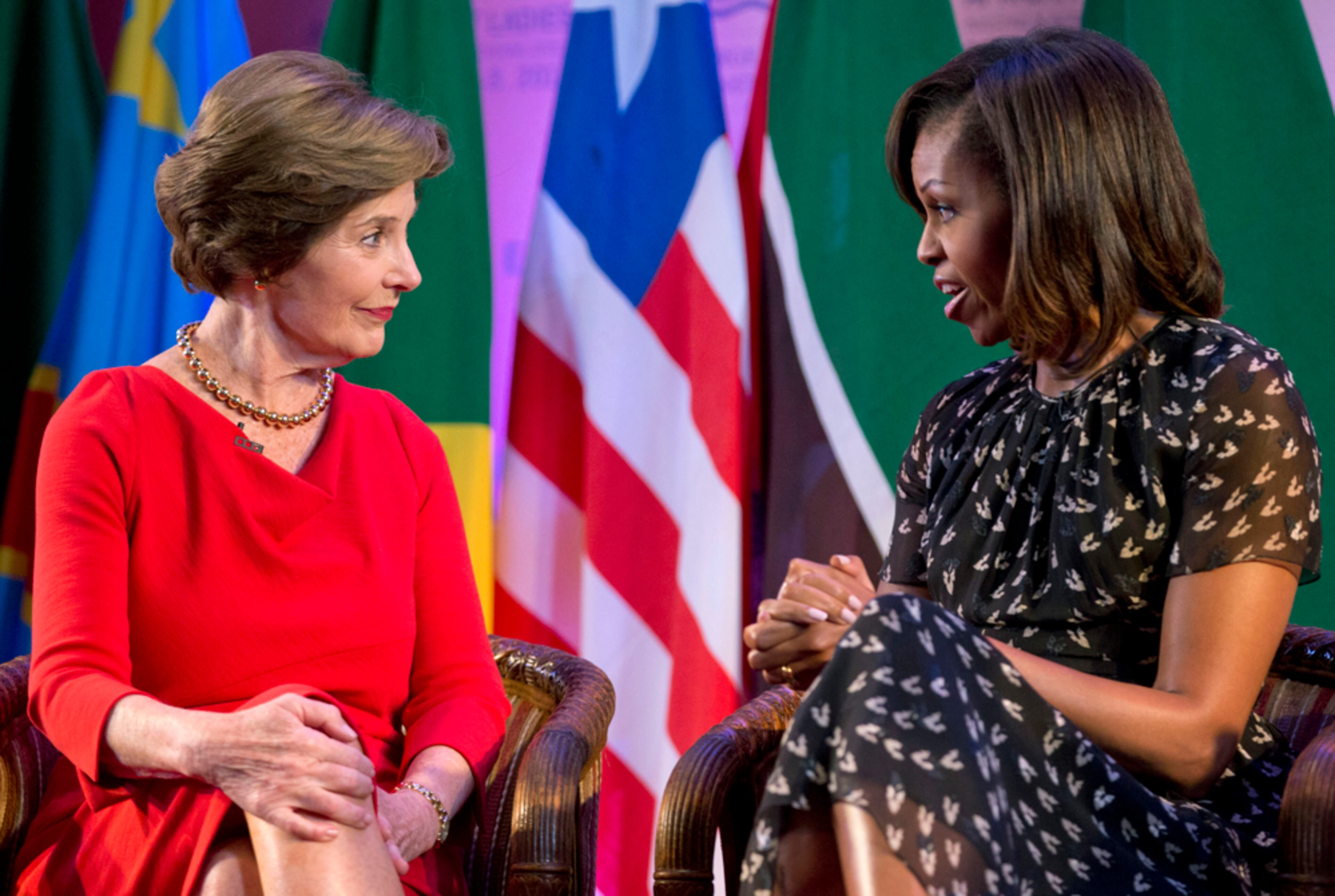 AFRICAN WOMEN'S SUMMIT--U.S. first lady Michelle Obama, left, and former U.S. first lady Laura Bush look to each other as they participate in the African First Ladies Summit: "Investing in Women: Strengthening Africa," hosted by the George W. Bush Institute, Tuesday, July 2, 2013, in Dar es Salaam, Tanzania. (AP Photo/Carolyn Kaster)