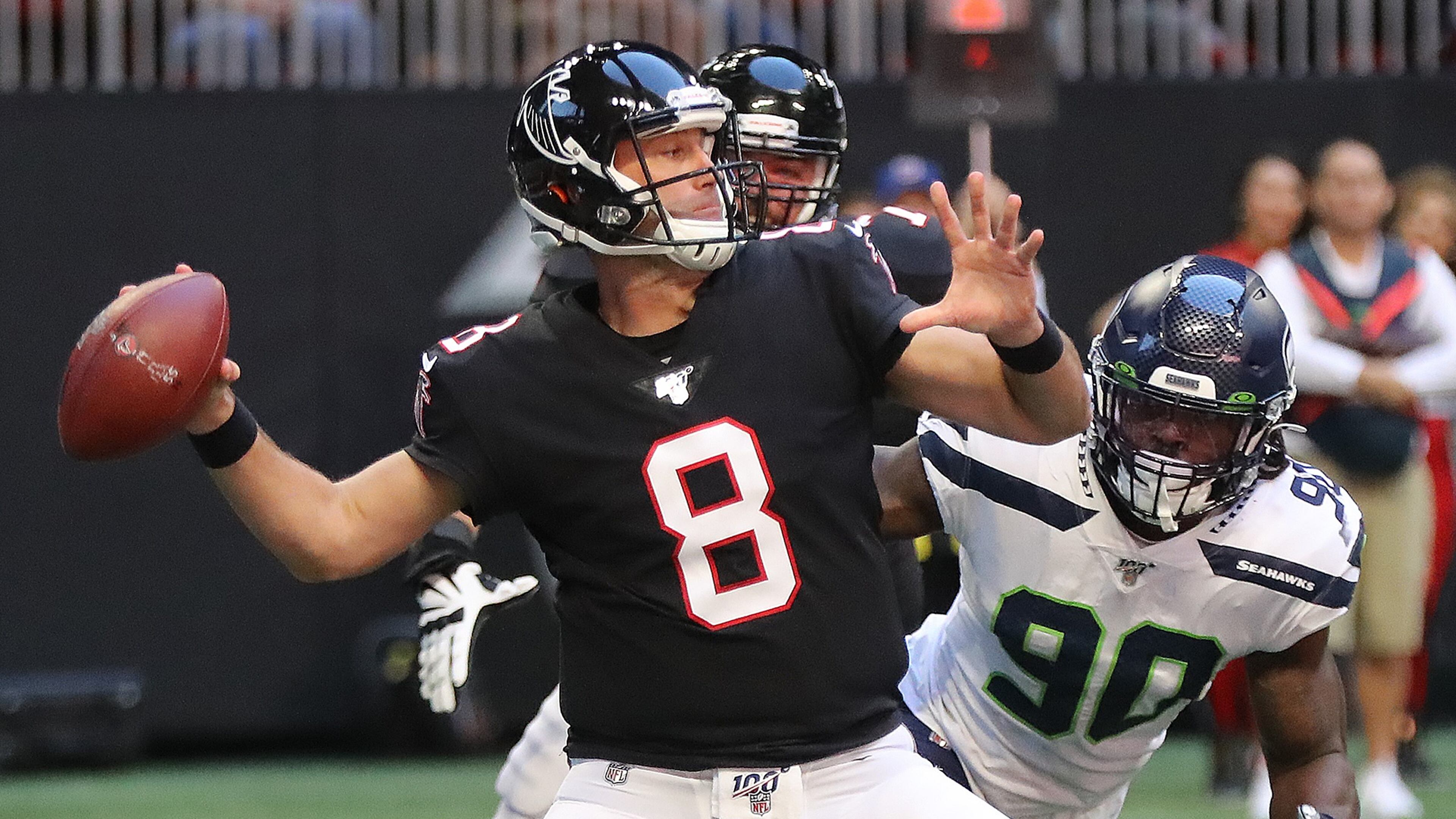 Atlanta Falcons quarterback Matt Schaub completes a pass under pressure from Seattle Seahawks defensive end Jadeveon Clowney during the second quarter in an NFL football game on Sunday, October 27, 2019, in Atlanta. Curtis Compton/ccompton@ajc.com
