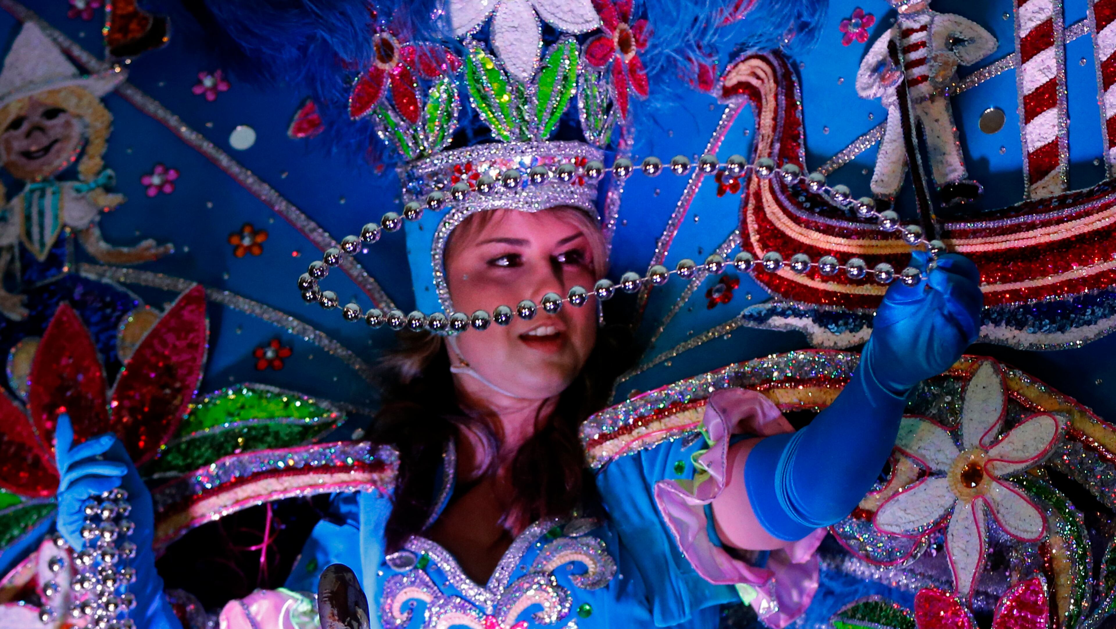 A Maid from the royal court of Endymion throws beads as the Krewe of Endymion Mardi Gras parade rolls through New Orleans, Saturday, Feb. 6, 2016. (AP Photo/Gerald Herbert)