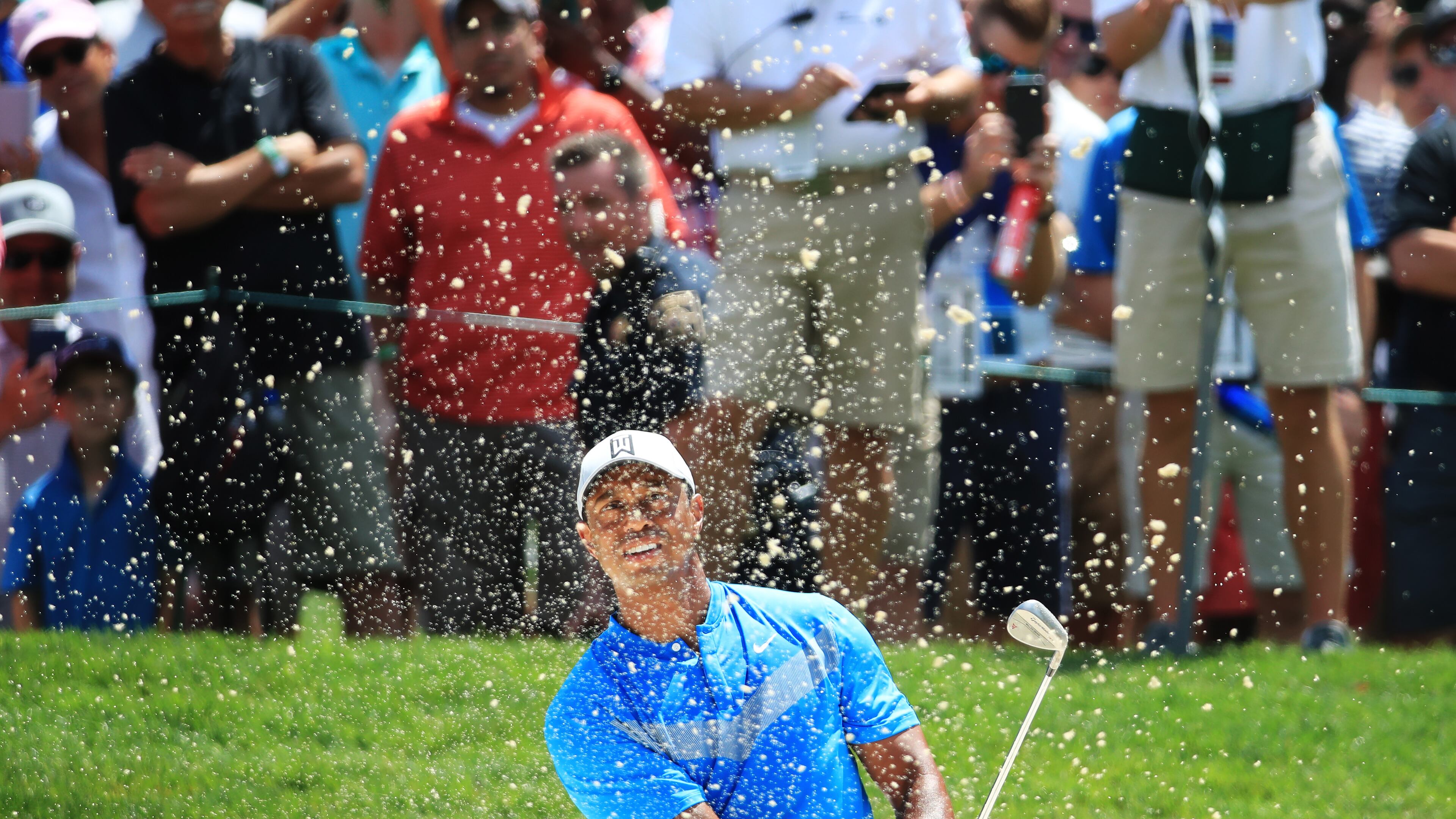 Tiger Woods supplies one of the standard blast-out-of-the-bunker photos Thursday during the first round of the BMW Championship. (Photo by Andrew Redington/Getty Images)