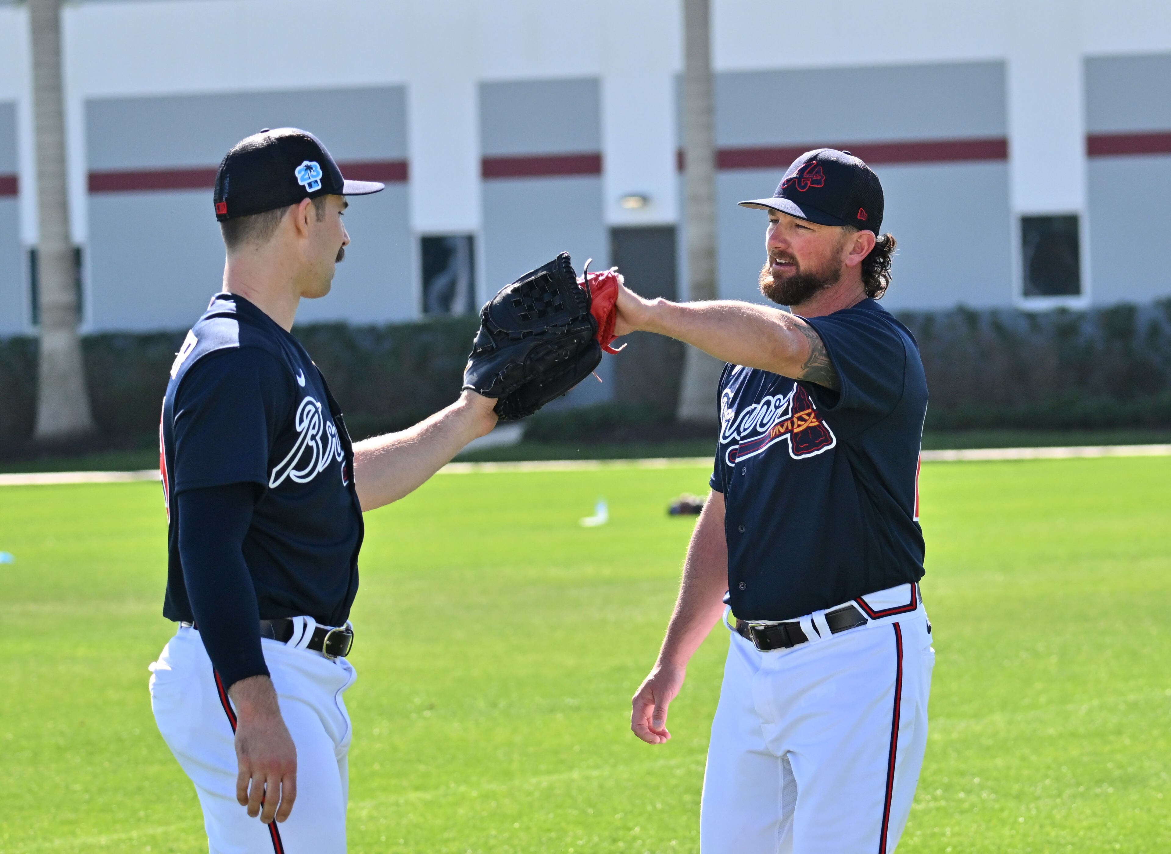 Braves pitcher Spencer Strider (left) greets pitcher Kirby Yates during spring training Thursday at CoolToday Park in North Port, Florida. (Hyosub Shin / Hyosub.Shin@ajc.com)