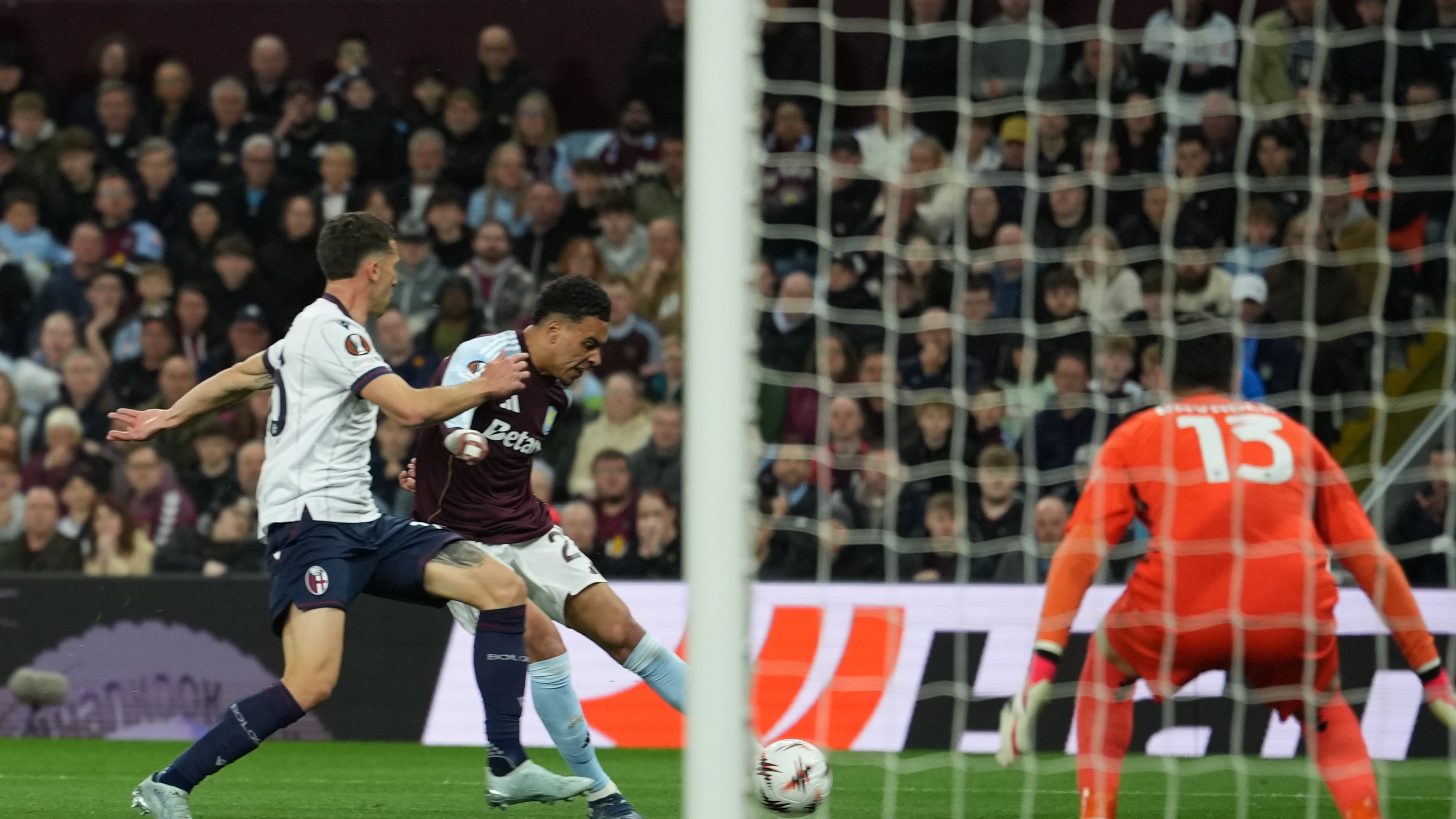 Aston Villa's Morgan Rogers scores his side's third goal during the Europa League quarterfinal second leg soccer match between Aston Villa and Bologna, in Birmingham, England, Thursday, April 16, 2026. (AP Photo/Dave Shopland)