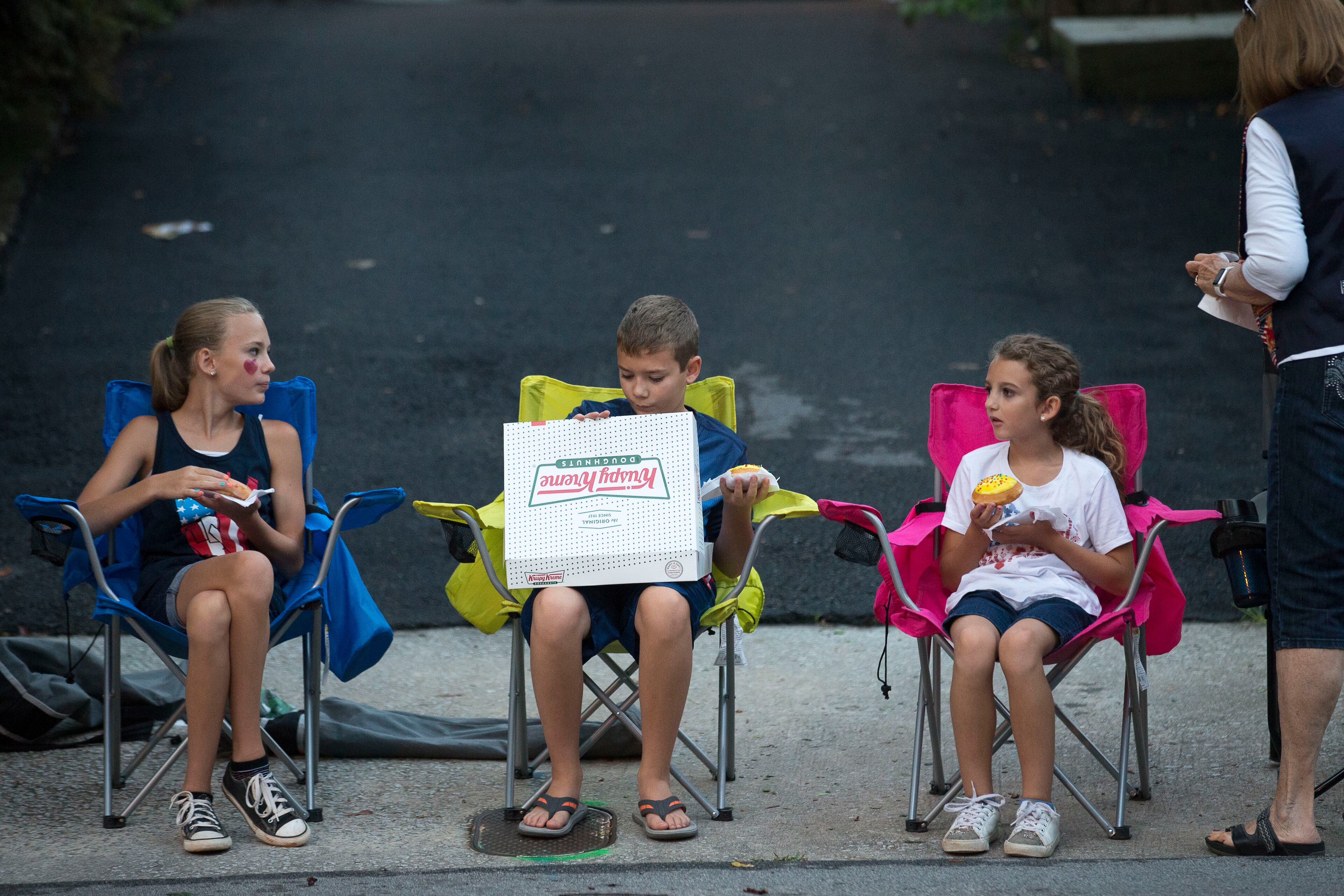 Mackenzie (left), Connor (center), and Kaylee Middlebrooks share a morning snack during the 49th running of the AJC Peachtree road race near Piedmont Park, Wednesday, July 4, 2018. ALYSSA POINTER/ALYSSA.POINTER@AJC.COM