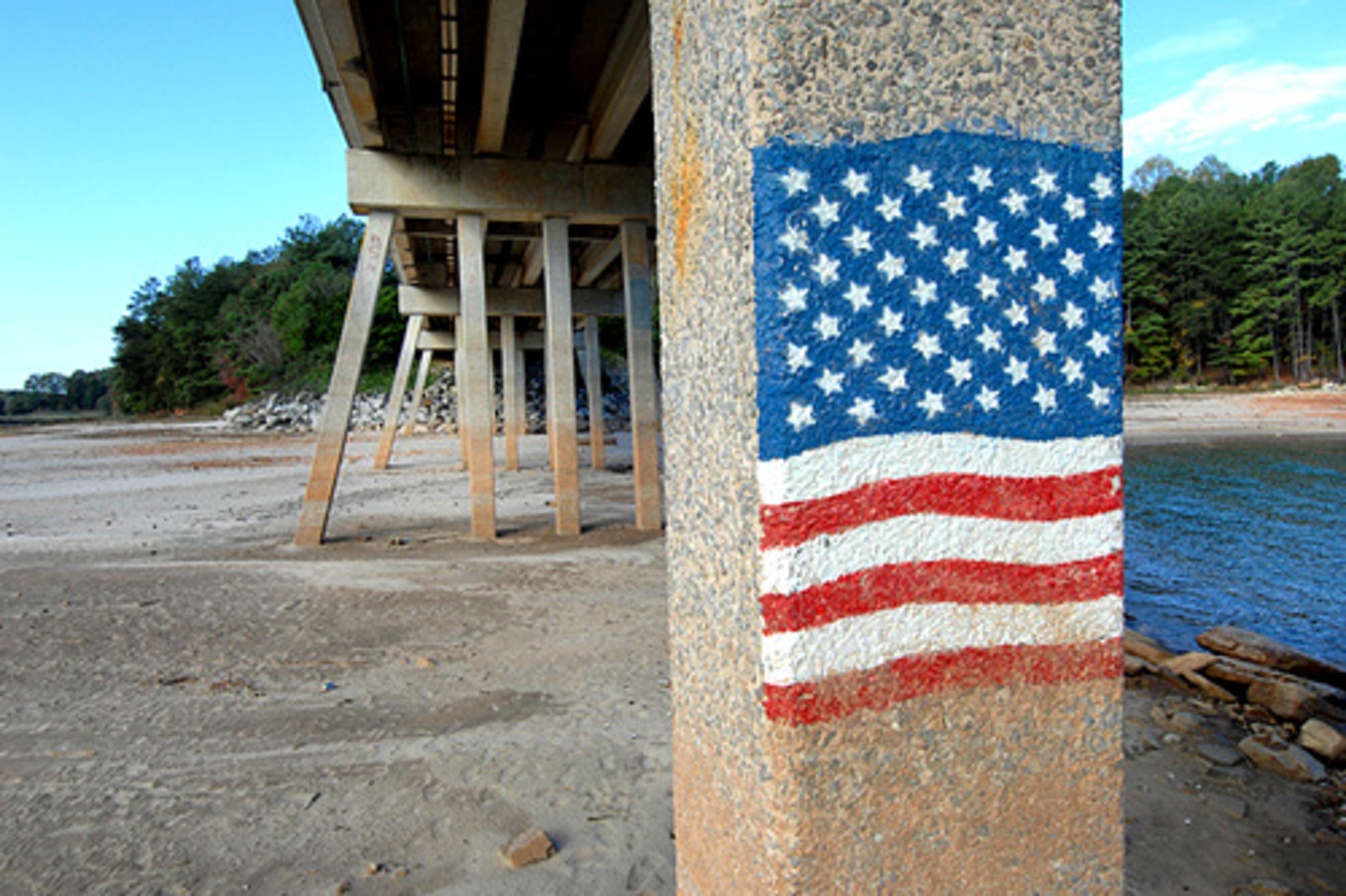 At the bridge at Lake Lanier Islands, this flag, which is about 13 feet above ground, could only have been painted from a boat tied to the pillar. The picture was taken using a camera on a monopod held above the photographer's head.