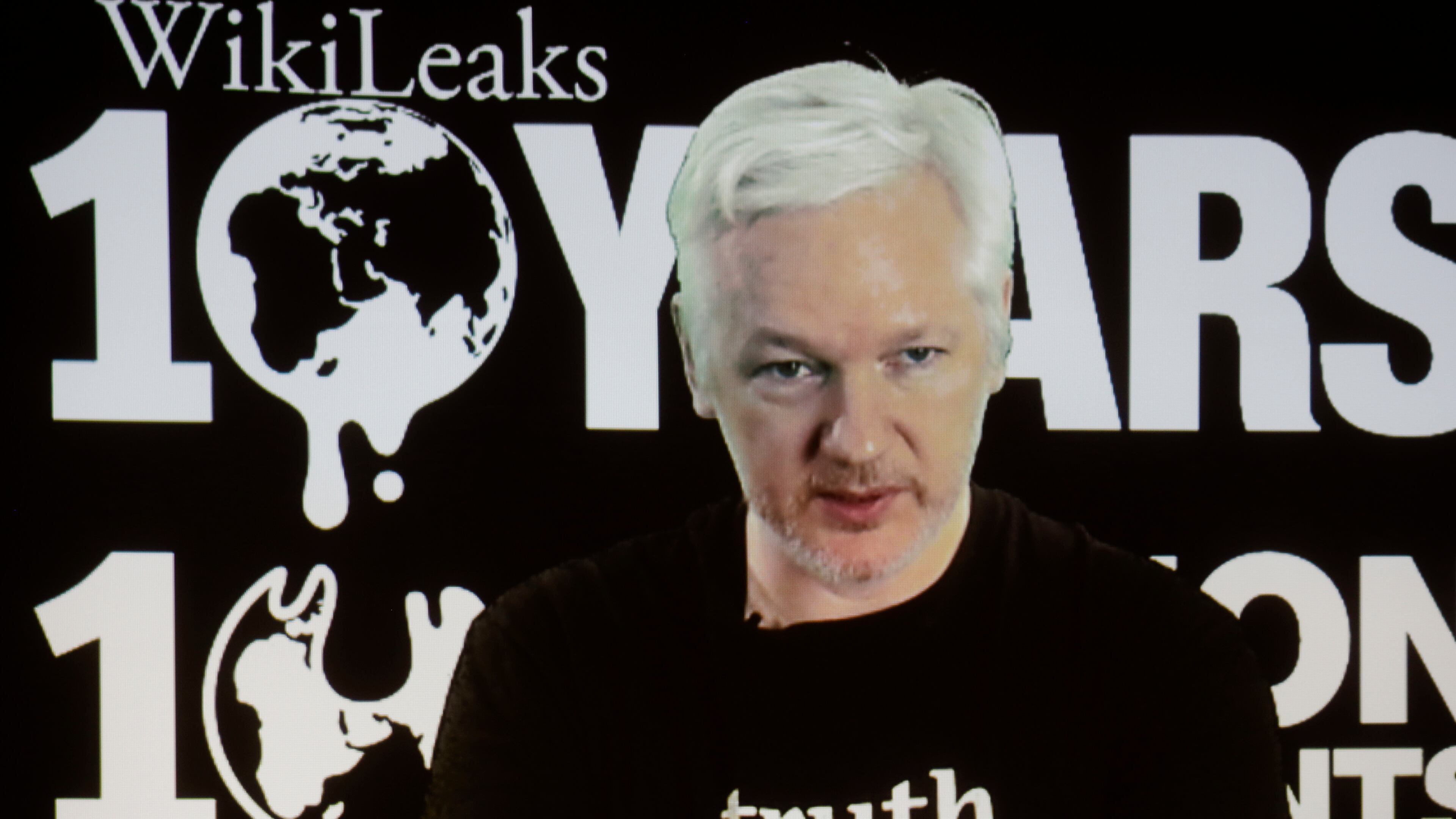 WikiLeaks founder Julian Assange participates via video link at a news conference marking the 10th anniversary of the secrecy-spilling group in Berlin, Germany, Tuesday, Oct. 4, 2016. Assange said that WikiLeaks plans to start a series of publications this week, but wouldn’t specify the timing and subject. (AP Photo/Markus Schreiber)