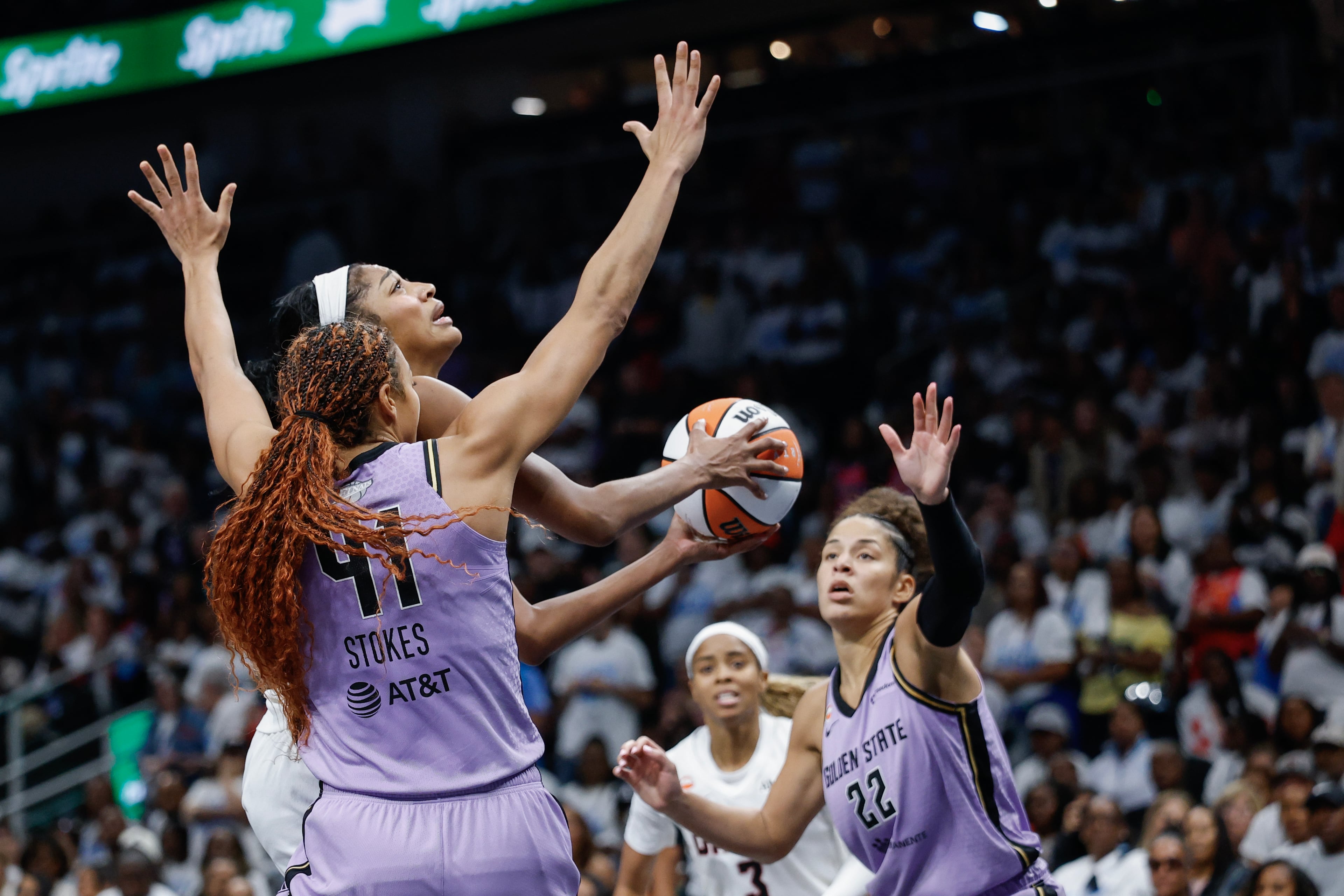 Atlanta Dream forward Angel Reese is defended by Golden State Valkyries center Kiah Stokes (left) and guard Veronica Burton during the second half of Game 4 of the WNBA Finals between the Atlanta Dream and the Golden State Valkyries, Saturday, Oct. 24, 2026, in Atlanta. (Erik S. Lesser for the AJC)