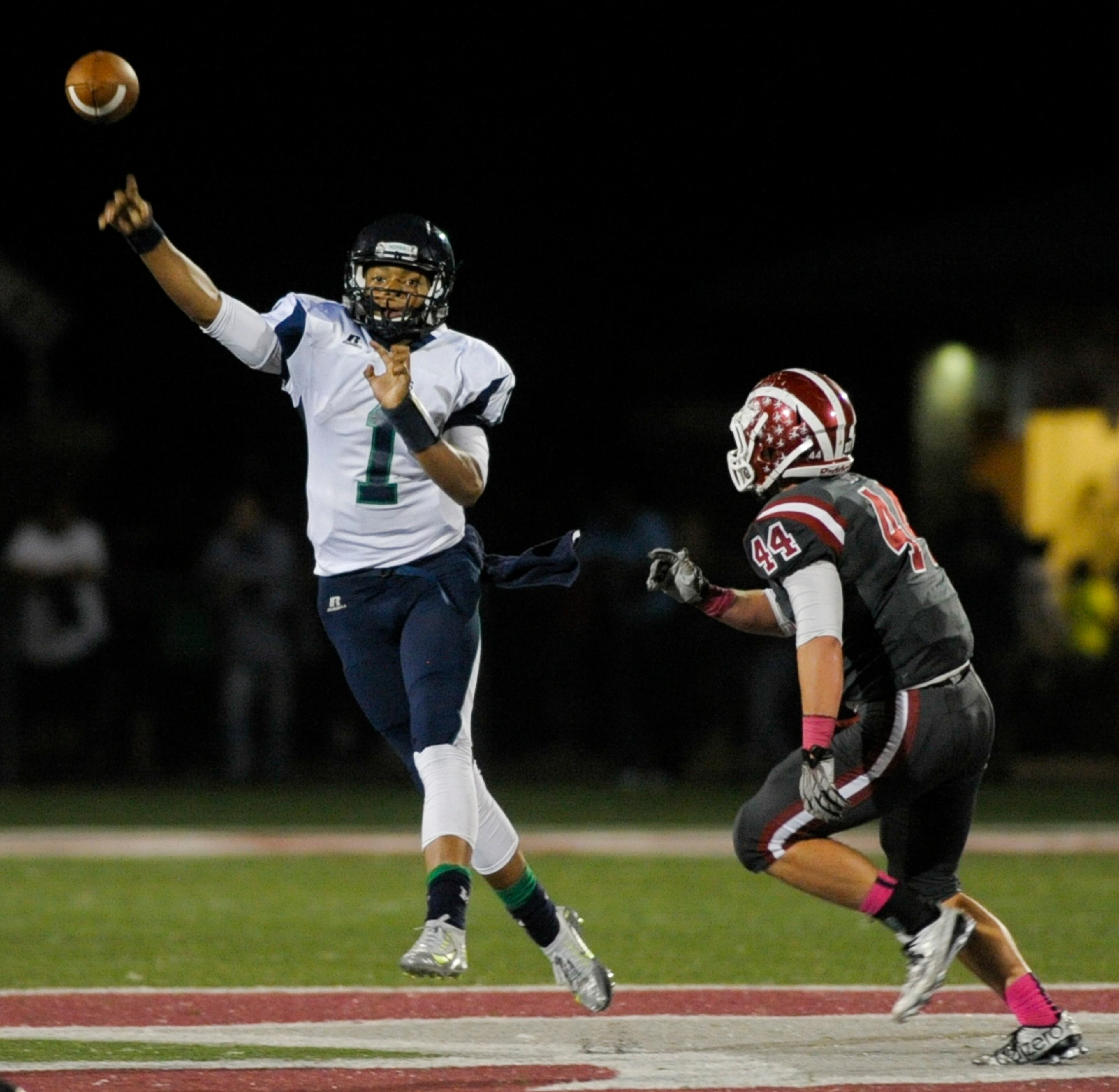 Powder Springs, Ga. -- Harrison sophomore QB Justin Fields (1) releases a pass as Hillgrove senior defensive lineman Spencer Metcalfe (44) defends during the first half of their football game at Hillgrove High. Friday, October 23, 2015. Special/Daniel Varnado