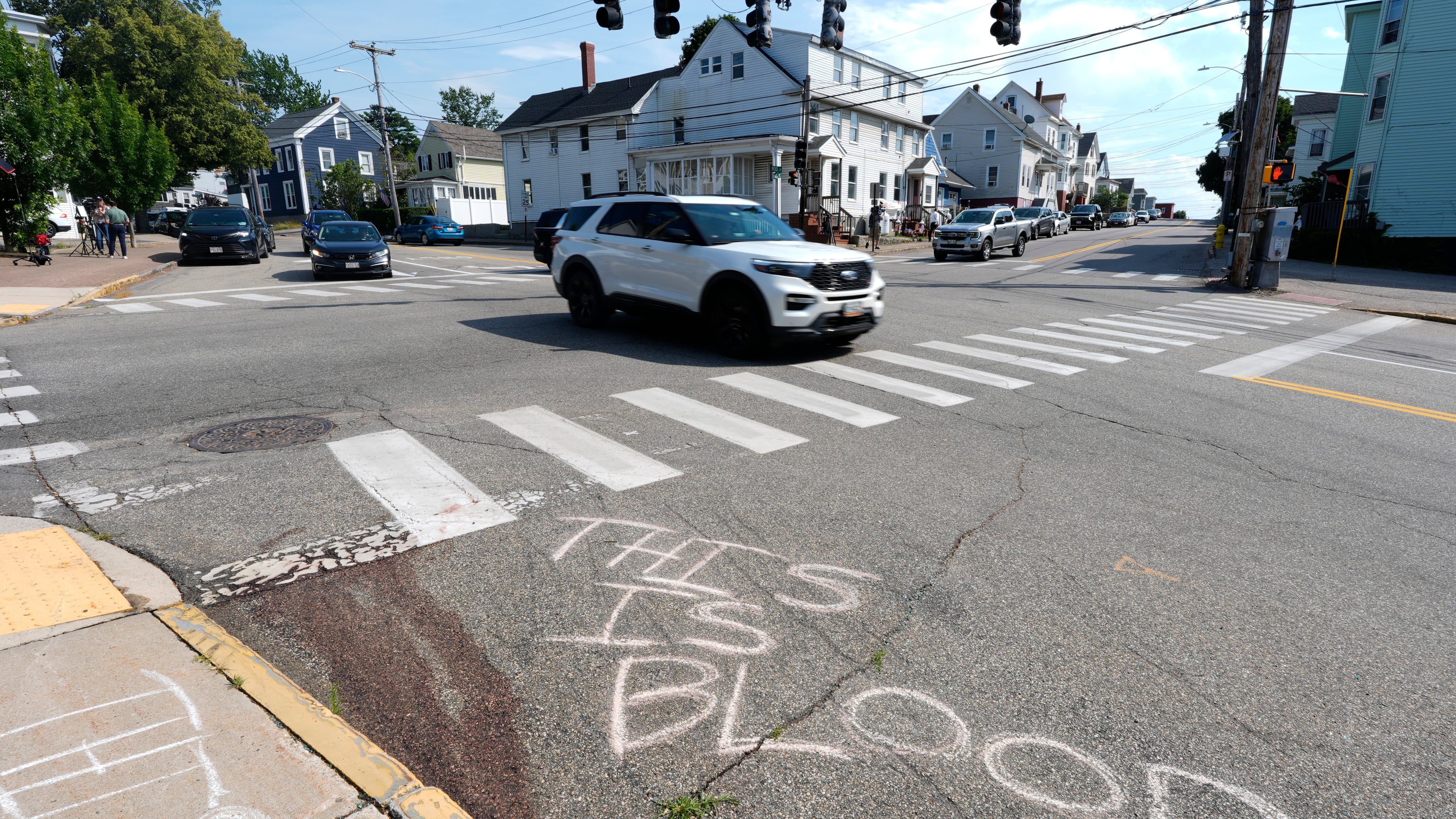 Blood is seen on the pavement near the scene of a shooting involving U.S. Immigration and Customs Enforcement, Monday, July 13, 2026 in Biddeford, Maine. (AP Photo/Robert F. Bukaty)