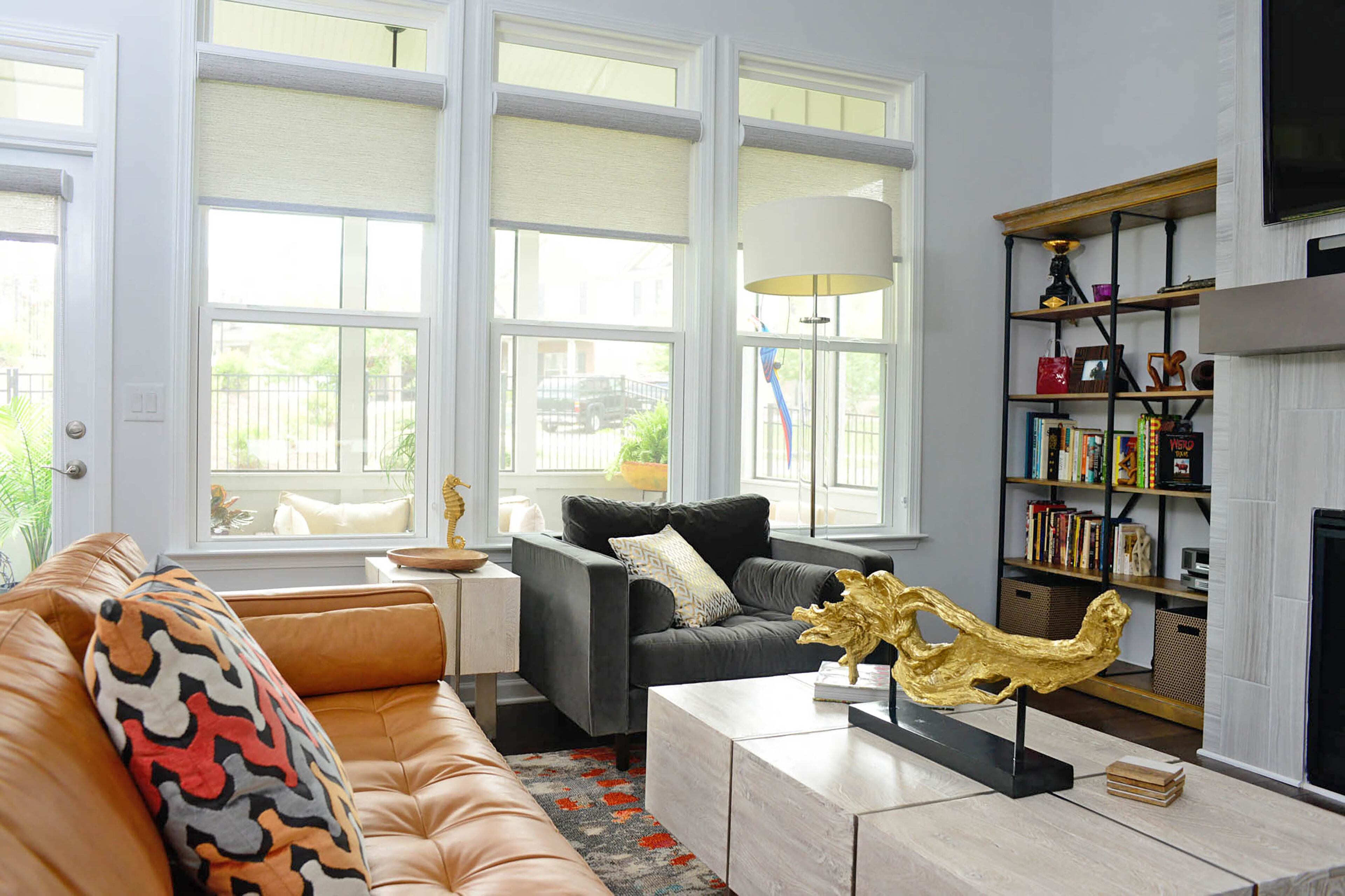 The Clifton whitewashed mango coffee table and matching rectangular end table from Z Gallerie center the seating area in the living room. The windows across the back flood the room with natural light, keeping it airy and bright, Charyl Ware said.