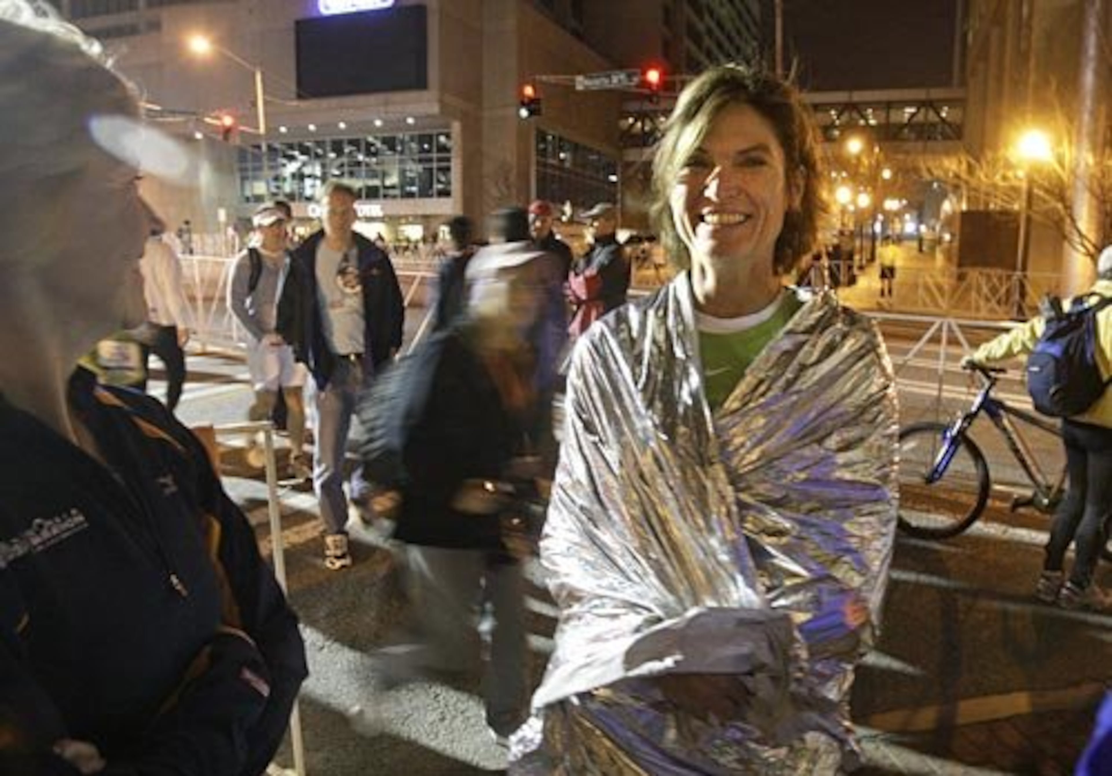 Stay warm: Marietta's Valerie Breslow wraps herself in a heat blanket while waiting for the race to start. The early morning weather was cool and rainy.