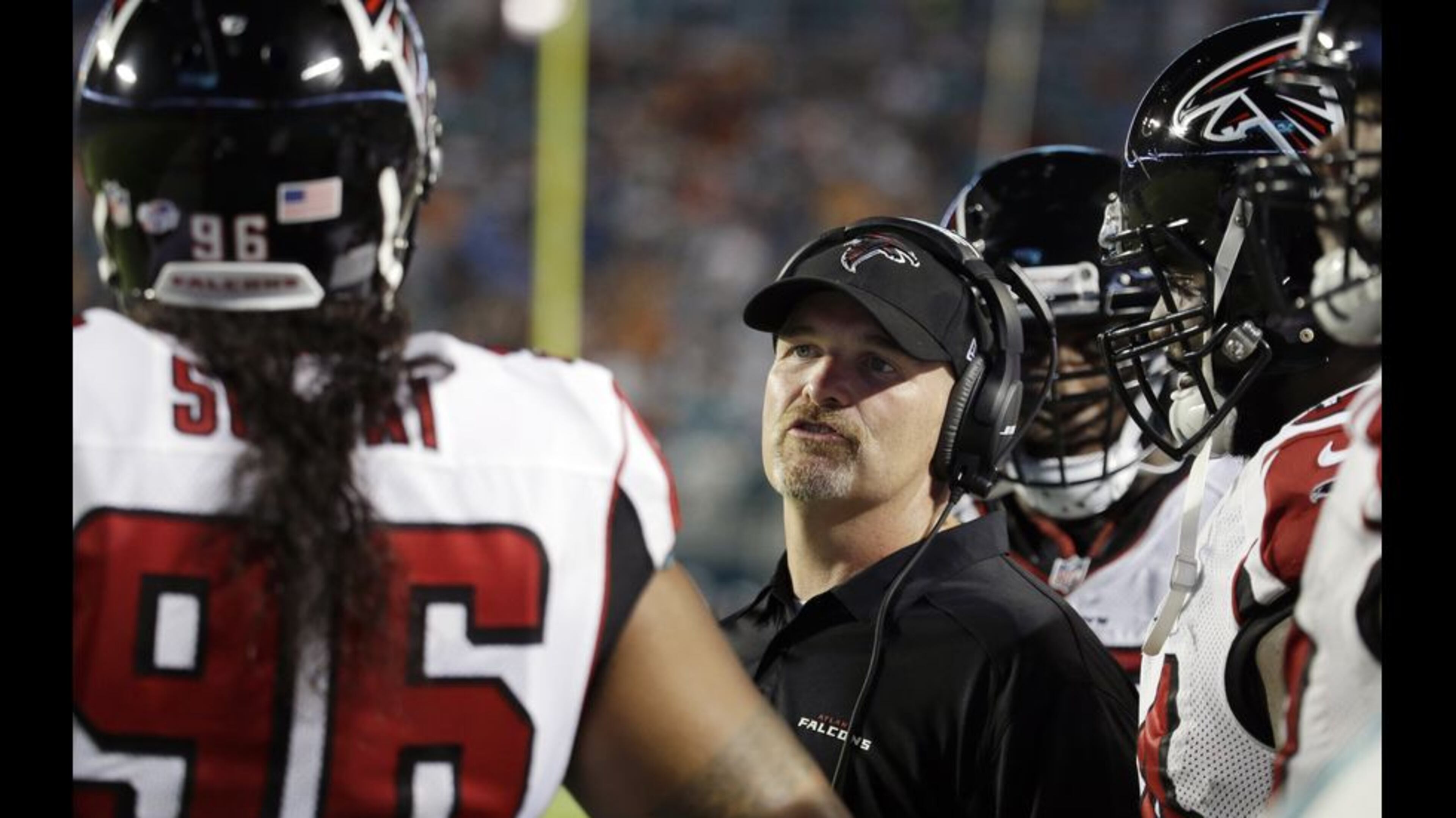Atlanta Falcons head coach Dan Quinn speaks to Atlanta Falcons defensive tackle Paul Soliai (96) during the first half of a preseason NFL football game, Saturday, Aug. 29, 2015 in Miami Gardens, Fla. (AP Photo/Lynne Sladky)