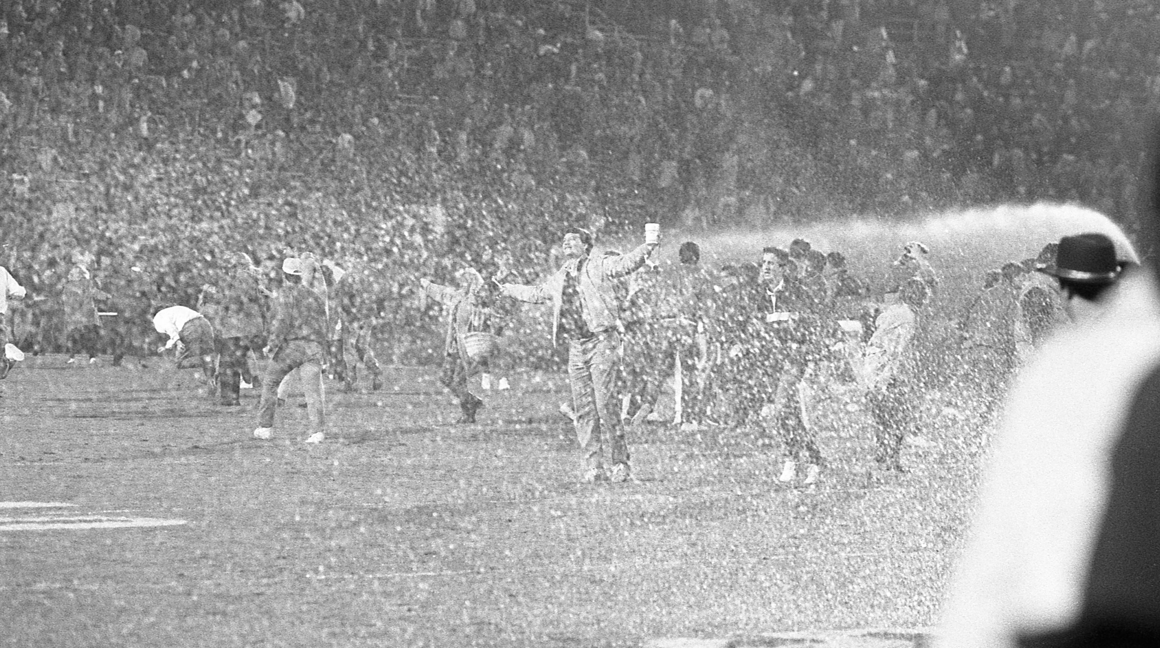 Fans are sprayed as they celebrate on the field at Jordan-Hare. Photo by Louie Favorite / AJC