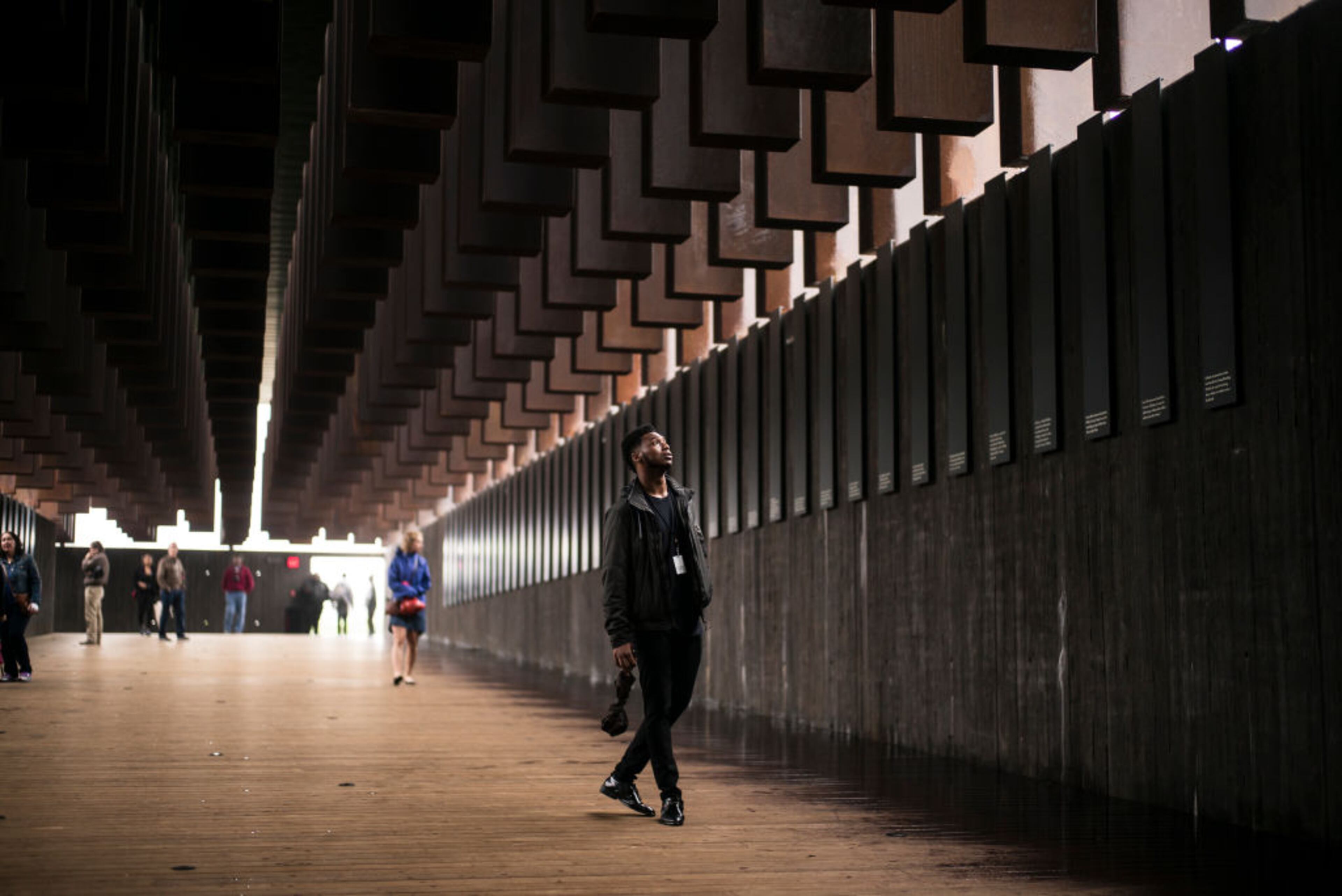 MONTGOMERY, AL - APRIL 26: Veric Lang, 19, visits the National Memorial For Peace And Justice on April 26, 2018 in Montgomery, Alabama. "Itâs powerful," Lang said. "Seeing the list of names and the reasons why people were killed, it's eye opening to know what society was like back then. It make me uneasy to know what this is what my people went through. Iâm glad times have changed now, but there still a lot more we have to do." The memorial is dedicated to the legacy of enslaved black people and those terrorized by lynching and Jim Crow segregation in America. Conceived by the Equal Justice Initiative, the physical environment is intended to foster reflection on America's history of racial inequality. (Photo by Bob Miller/Getty Images)