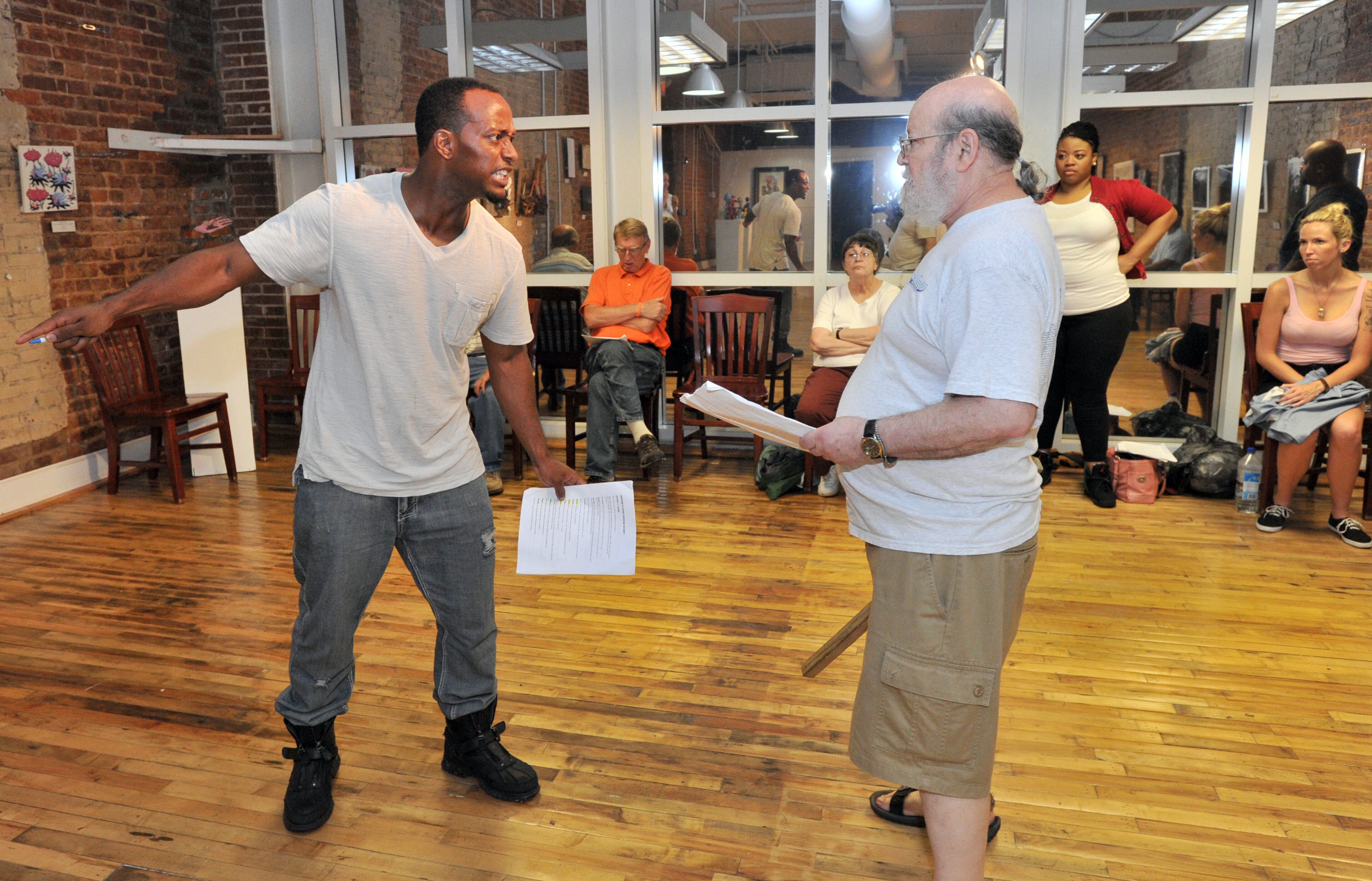 Toddrick Thomas (foreground left) and Bob Caine perform during the rehearsal of Moore's Ford Lynching Reenactment at Fuse Arts Center in Atlanta on Wednesday, July 17, 2013.