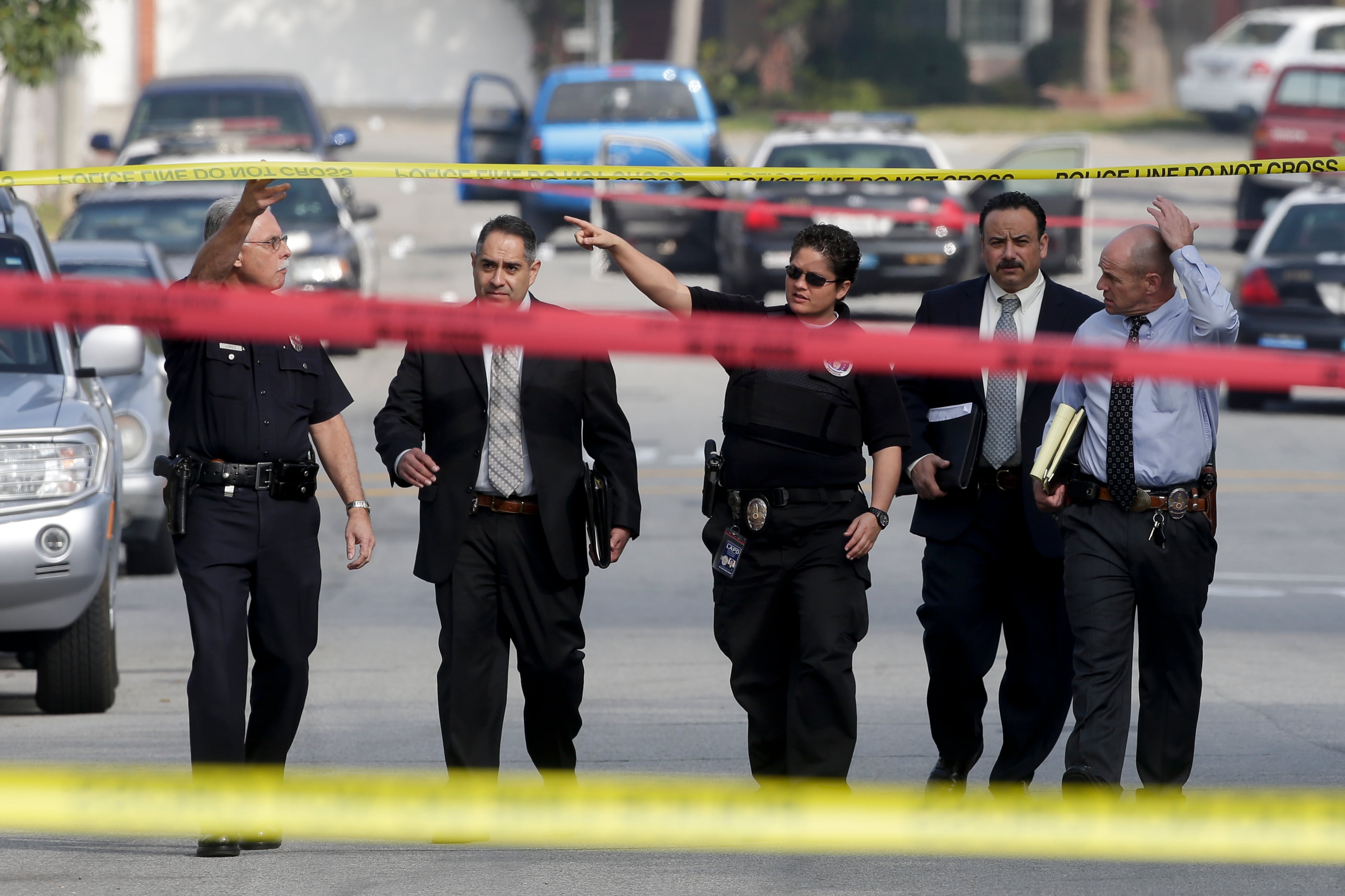 Law enforcement members look over the scene of an officer involved shooting in Torrance, Calif. Thursday, Feb. 7, 2013.