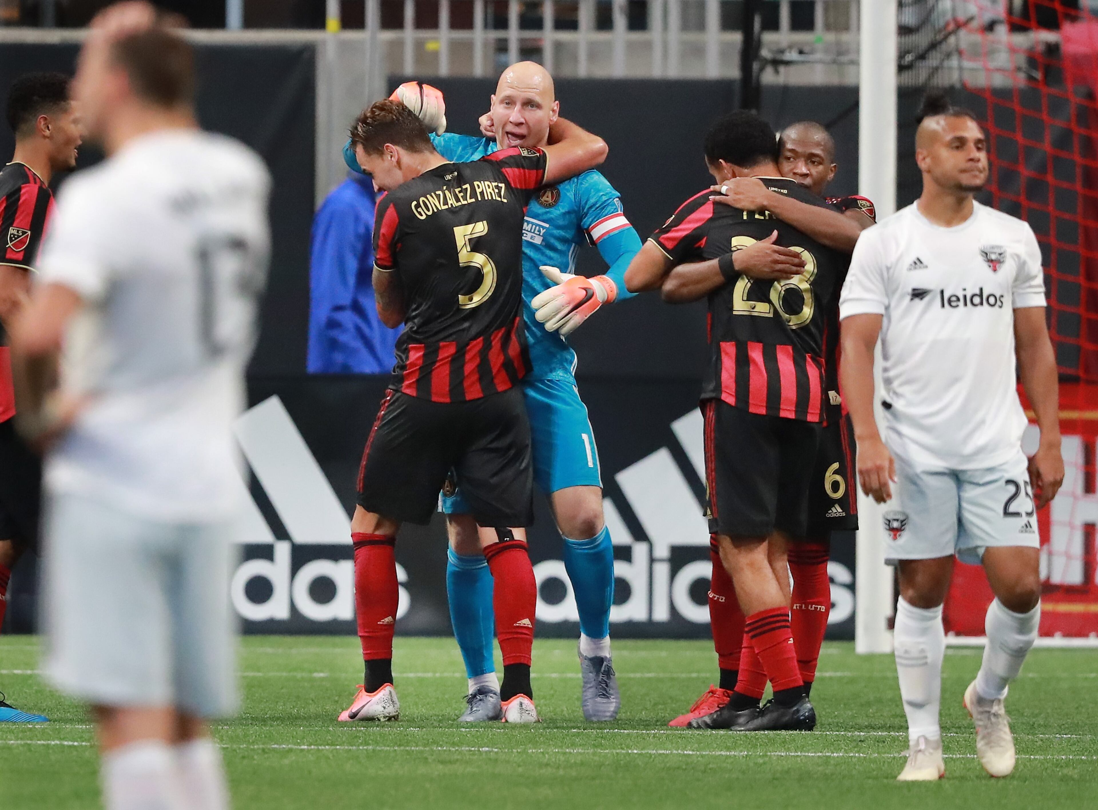 July 21, 2019 Atlanta: Atlanta United goalkeeper Brad Guzan and defender Leandro Gonzalez Pirez (from left) and Dion Pereira and Darlington Nagbe celebrate a 2-0 victory over D.C. United while Quincey Amarikwa walks away dejected as time expires in a soccer match on Sunday, July 21, 2019, in Atlanta. Curtis Compton/ccompton@ajc.com