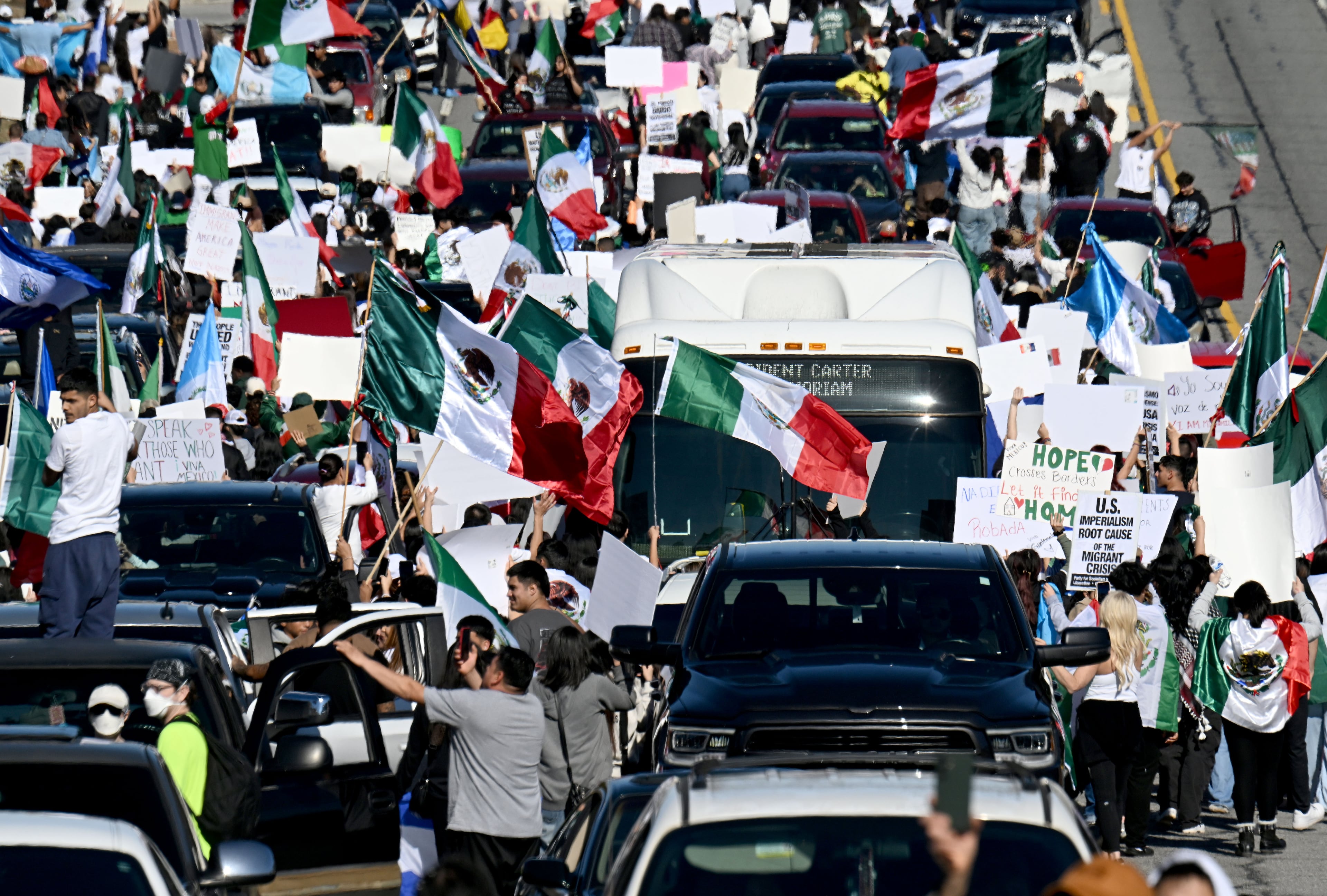Pro-immigration protesters march along Buford Highway as they waving flags from Mexico, Cuba, Guatemala and Puerto Rico, and carrying signs condemning deportations, Saturday, February 1, 2025, in Atlanta. About 1,000 protesters on Saturday gathered along Buford Highway, the immigrant hub of metro Atlanta, to call for an end to the targeted operations by immigration agents that began last week. (Hyosub Shin / AJC)