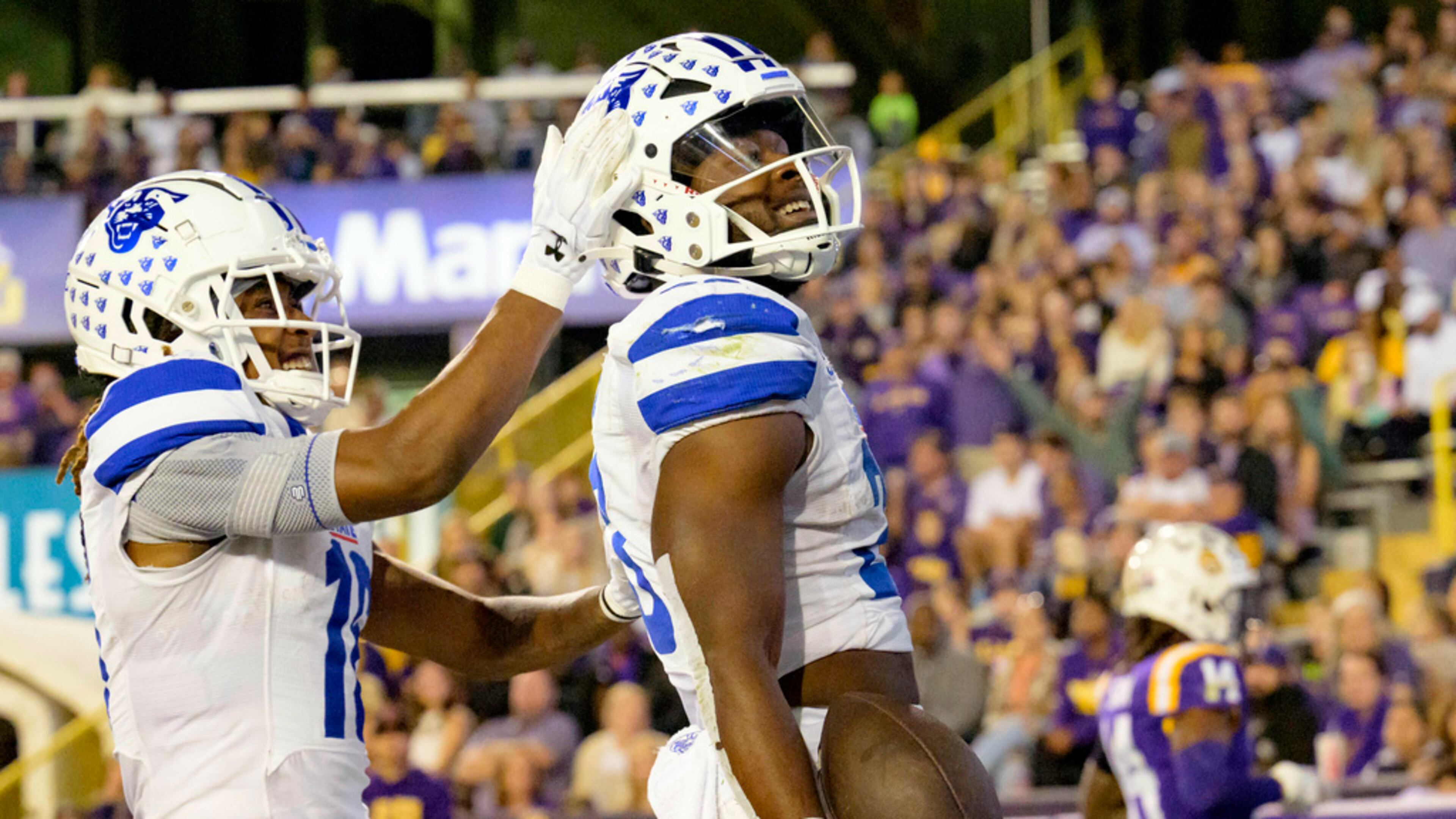 Georgia State running back Marcus Carroll, right, celebrates after his touchdown with wide receiver Tailique Williams, left, during the first half of an NCAA college football game against LSU in Baton Rouge, La., Saturday, Nov. 18, 2023. (AP Photo/Matthew Hinton)