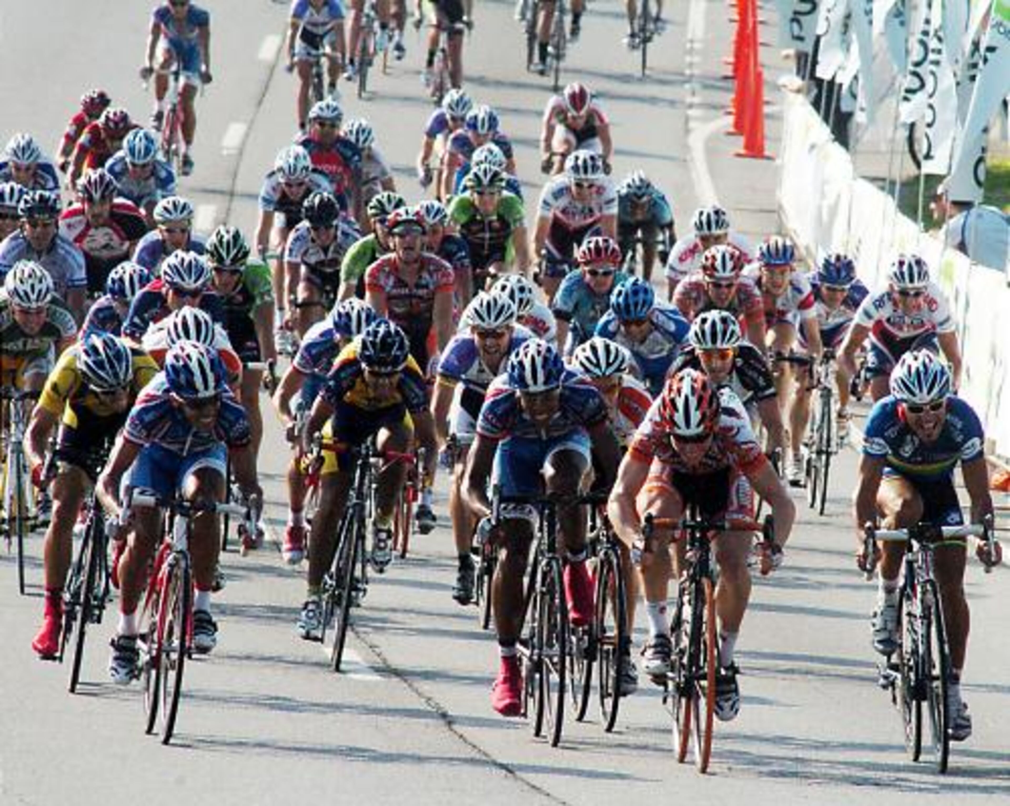 Cyclists make their way at the at the finish of the 100-kilometer men's bicycle race.
