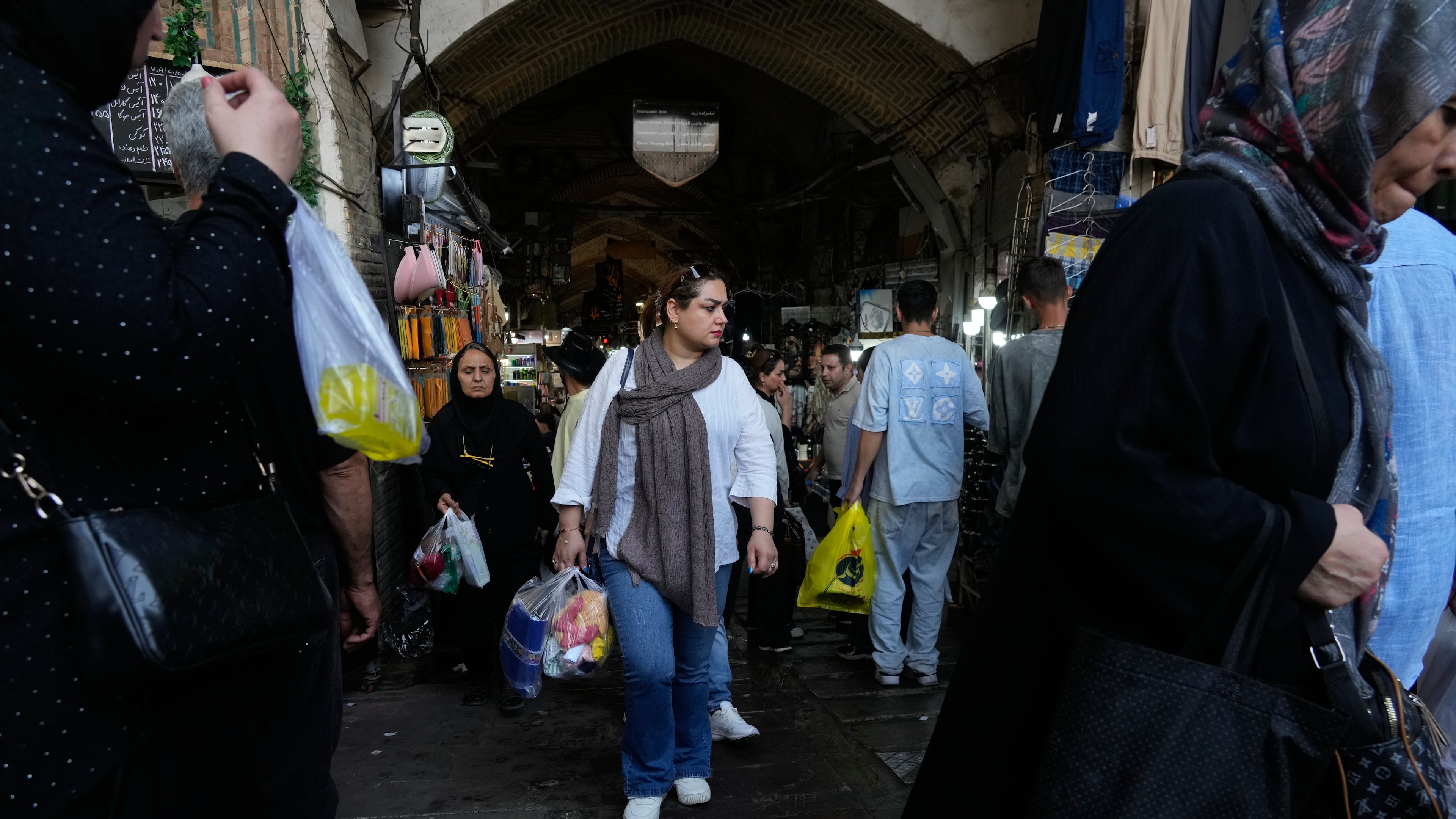 People walk at Tehran's traditional main bazaar, Iran, Saturday, Aug. 8, 2026. (AP Photo/Vahid Salemi)