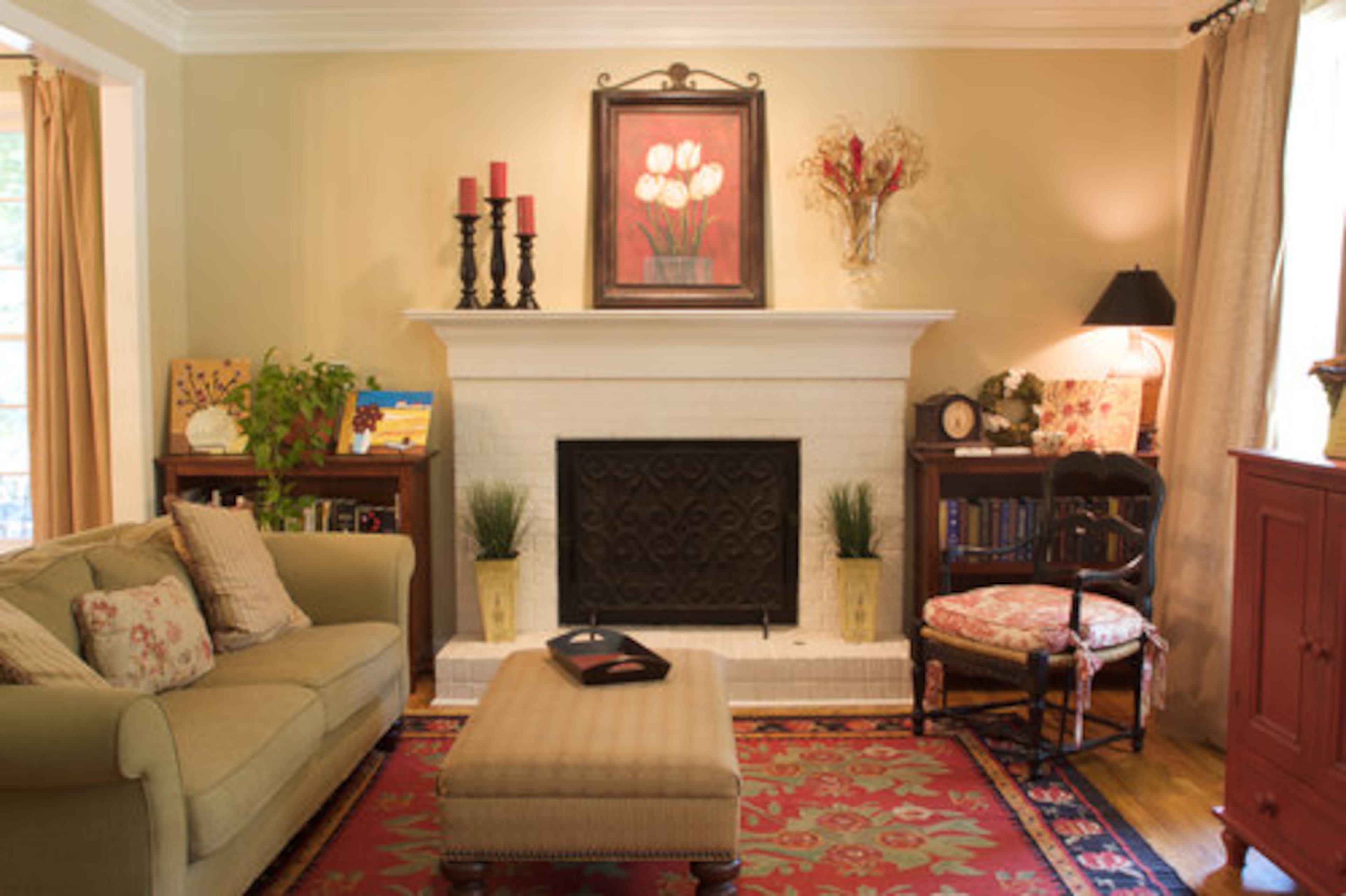The family room has a painted brick fireplace and hardwood floors. Each side of the mantle is adorned with artwork created in a local art class by Madi, 12, and Kate, 10.