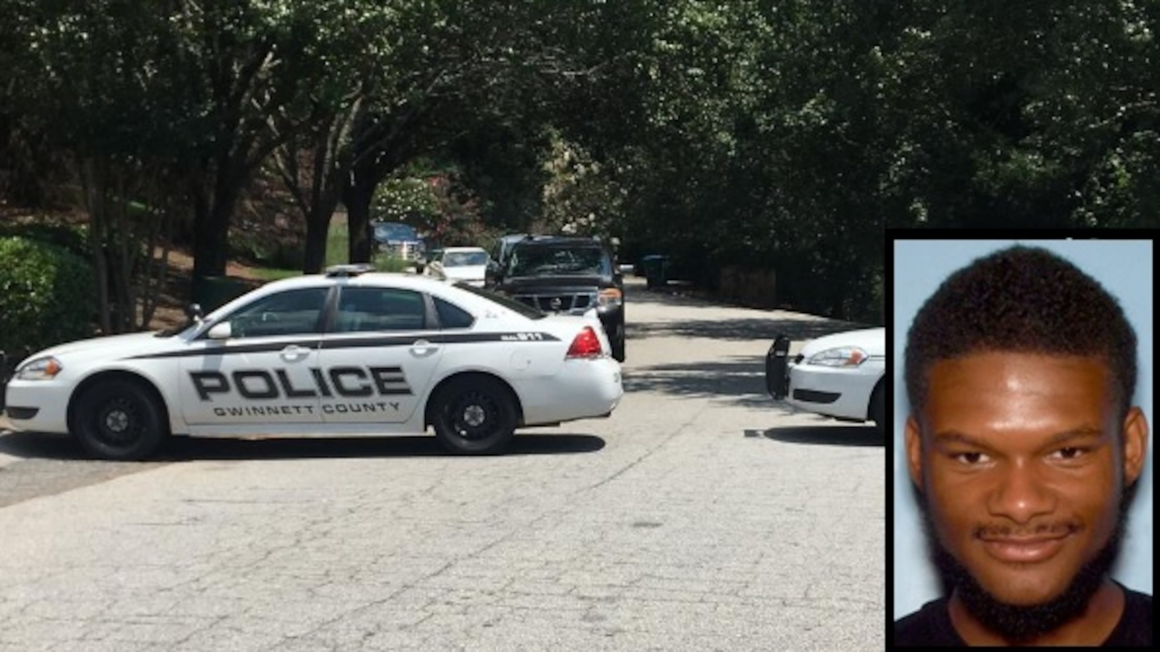 Police cars block off a cul-de-sac where a man and teenage boy were shot in Snellville on Thursday. Police have issued arrest warrants for Trevaughn McBriar, 18, in connection with the shooting.