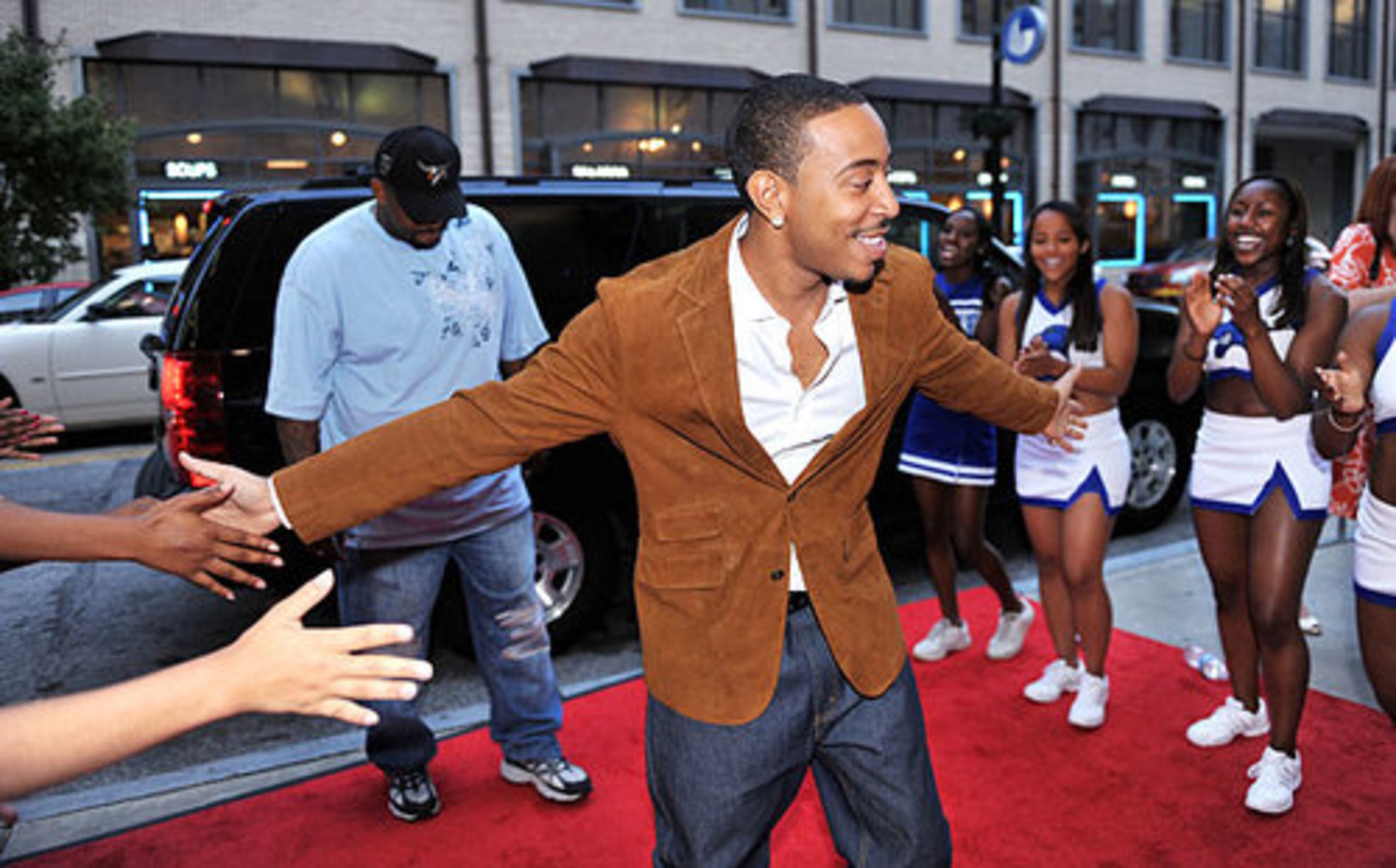 Atlanta's Chris "Ludacris" Bridges is greeted by Georgia State University cheerleaders as he arrives at the Rialto Center for the Arts. The rapper, actor and former GSU student was at the downtown theater for a special screening of his new action thriller, "Max Payne."
