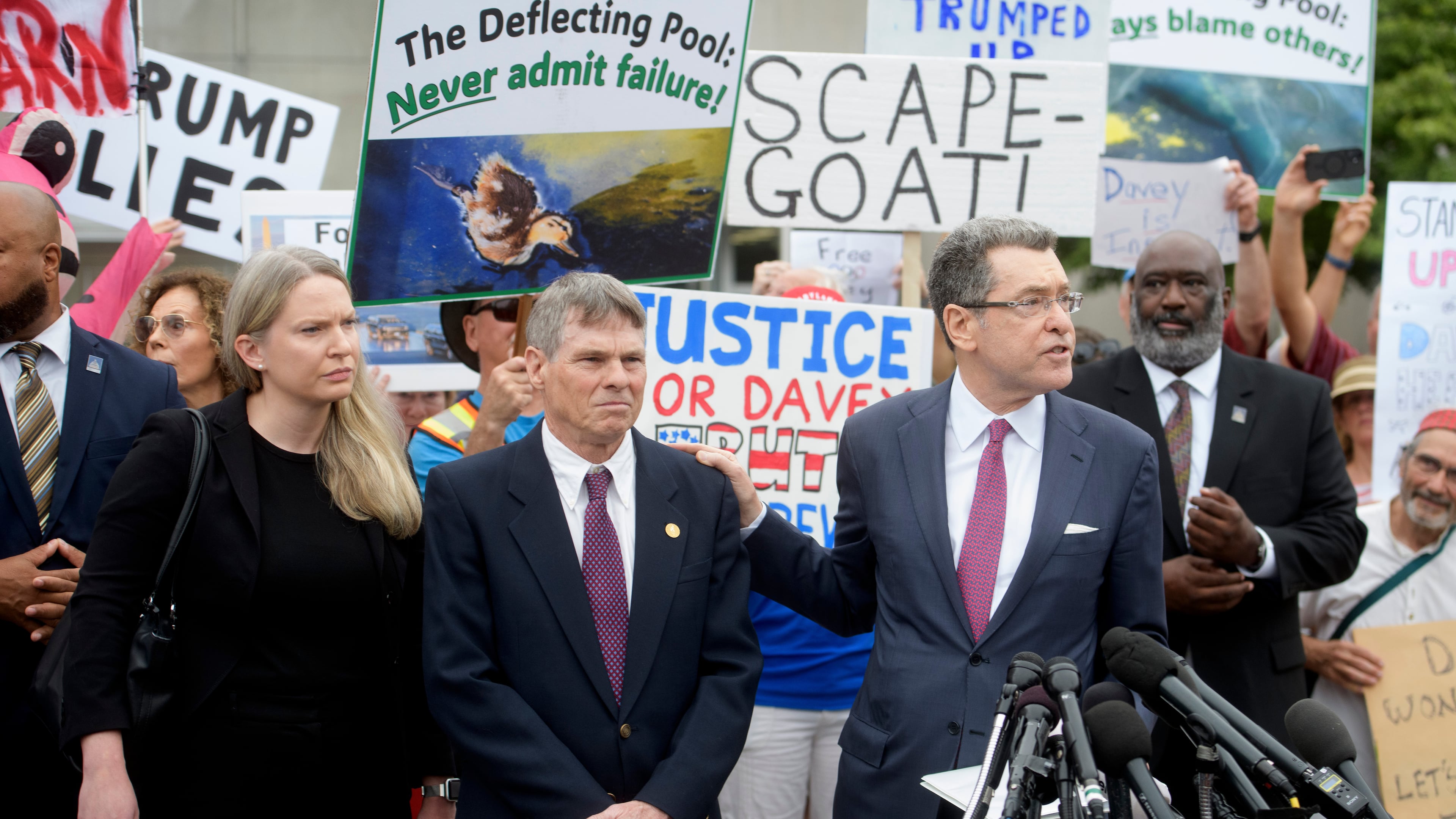 Former Olympic canoeist David Hearn, second from left, listens as his attorney Norman Eisen, right, speaks after he pleaded not guilty to allegedly damaging the Lincoln Memorial Reflecting Pool, Thursday, July 9, 2026, in Washington. (AP Photo/Rod Lamkey, Jr.)