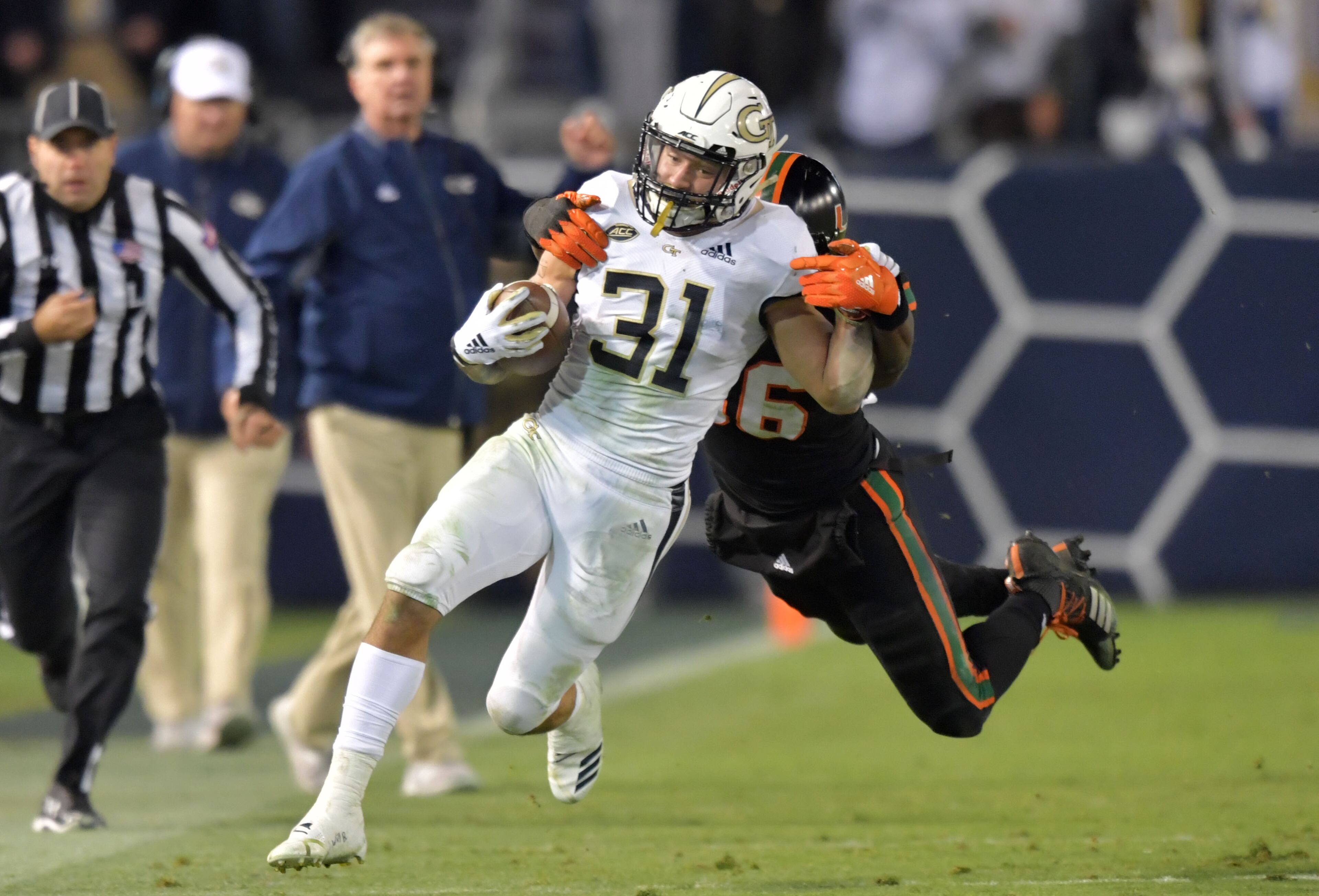 November 10, 2018 Atlanta - Georgia Tech running back Nathan Cottrell (31) eludes a tackle by Miami linebacker Michael Pinckney (56) in the second half at Bobby Dodd Stadium on Saturday, November 10, 2018. Georgia Tech won 27 - 21 over the Miami. HYOSUB SHIN / HSHIN@AJC.COM