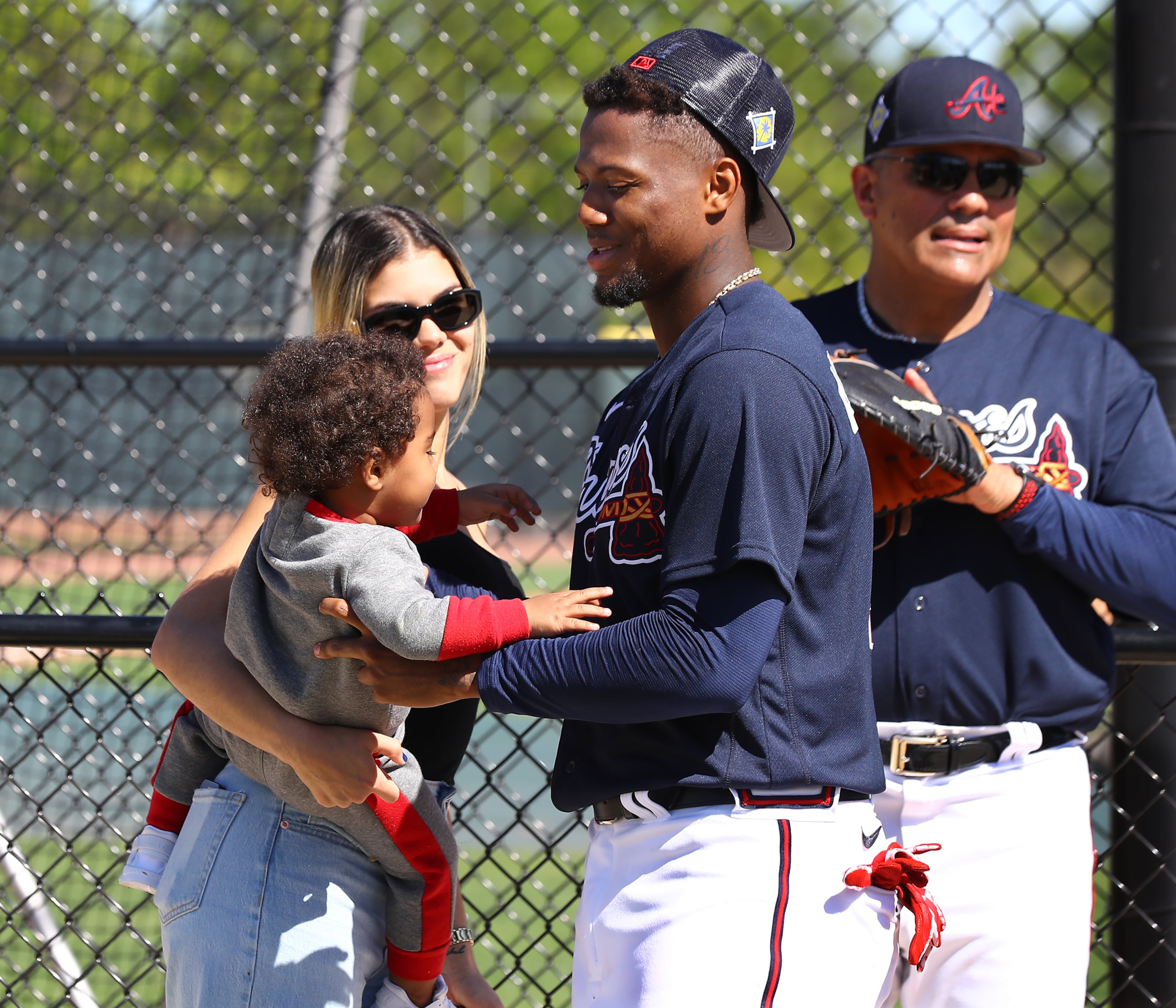 Braves outfielder Ronald Acuna gets his son Ronald Acuna Jr. II from his partner Maria Laborde after he finishes taking batting practice during Spring Training on Thursday, March 17, 2022, in North Port. “Curtis Compton / Curtis.Compton@ajc.com”