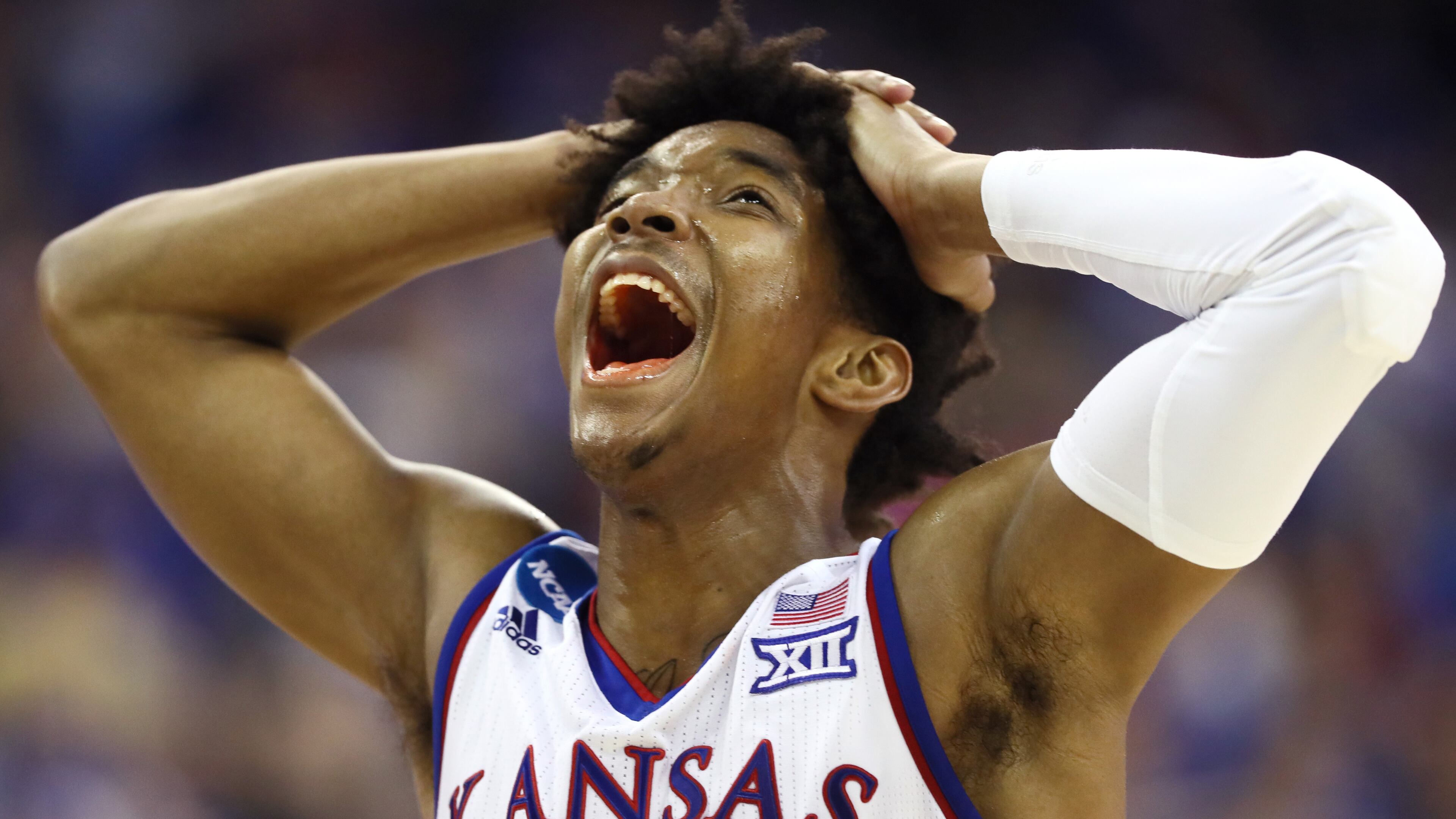 Devonte' Graham #4 of the Kansas Jayhawks reacts against the Duke Blue Devils during the second half in the 2018 NCAA Men's Basketball Tournament Midwest Regional at CenturyLink Center on March 25, 2018 in Omaha, Nebraska. (Photo by Jamie Squire/Getty Images)