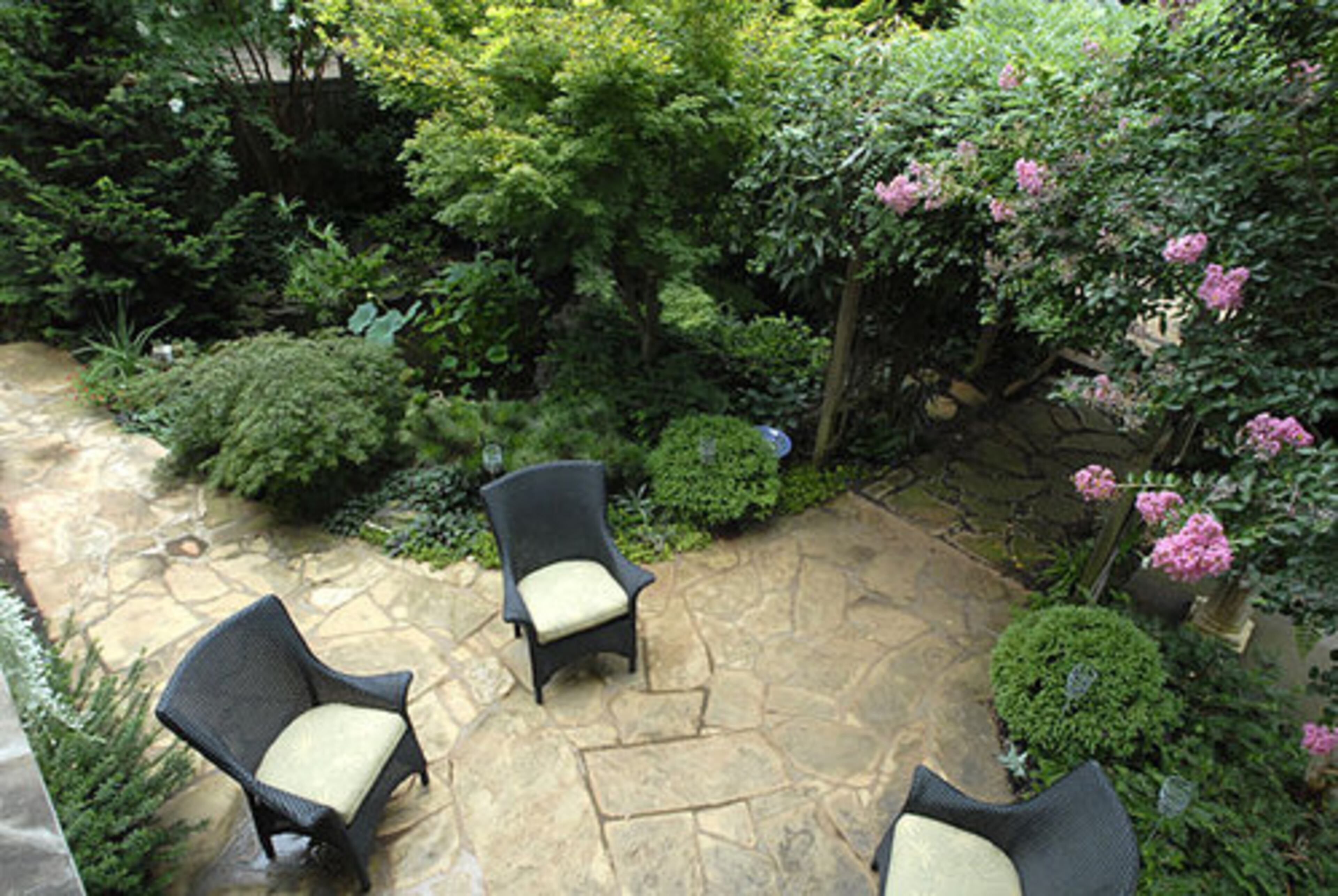 A sleeping porch was added to the second floor of their Avondale Estates home. From here, they can overlook the various garden rooms.