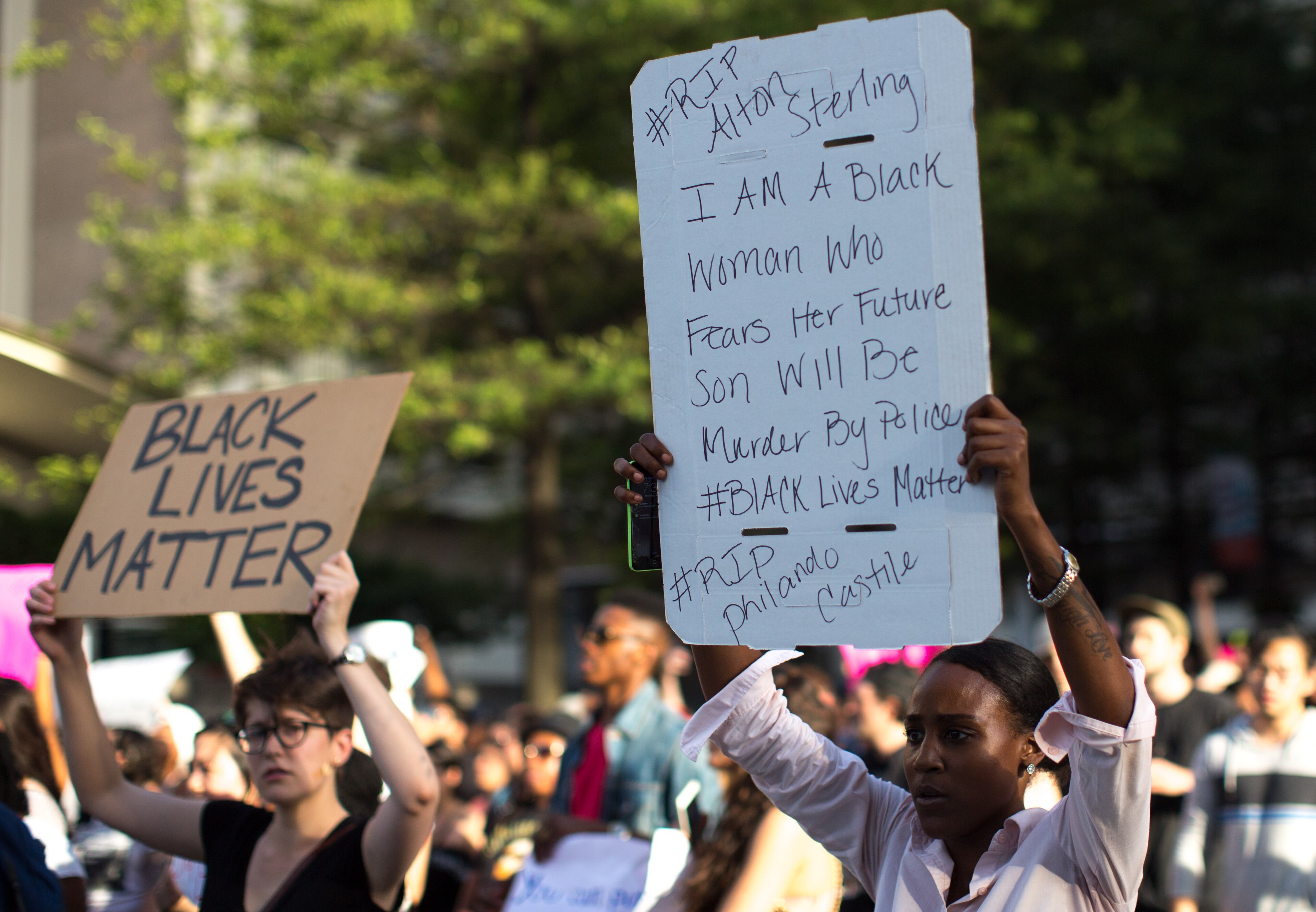 Demonstrators carry signs as they march down Peachtree Street to Piedmont Park, Thursday, July 7, 2016, in Atlanta. Demonstrators gathered in response to the death of 37-year-old Alton Sterling, who was killed by Baton Rouge police outside of a convenience store where he was selling CDs and Philando Castile, who was shot and killed when Minnesota police stopped him for a traffic violation on Wednesday evening. BRANDEN CAMP/SPECIAL