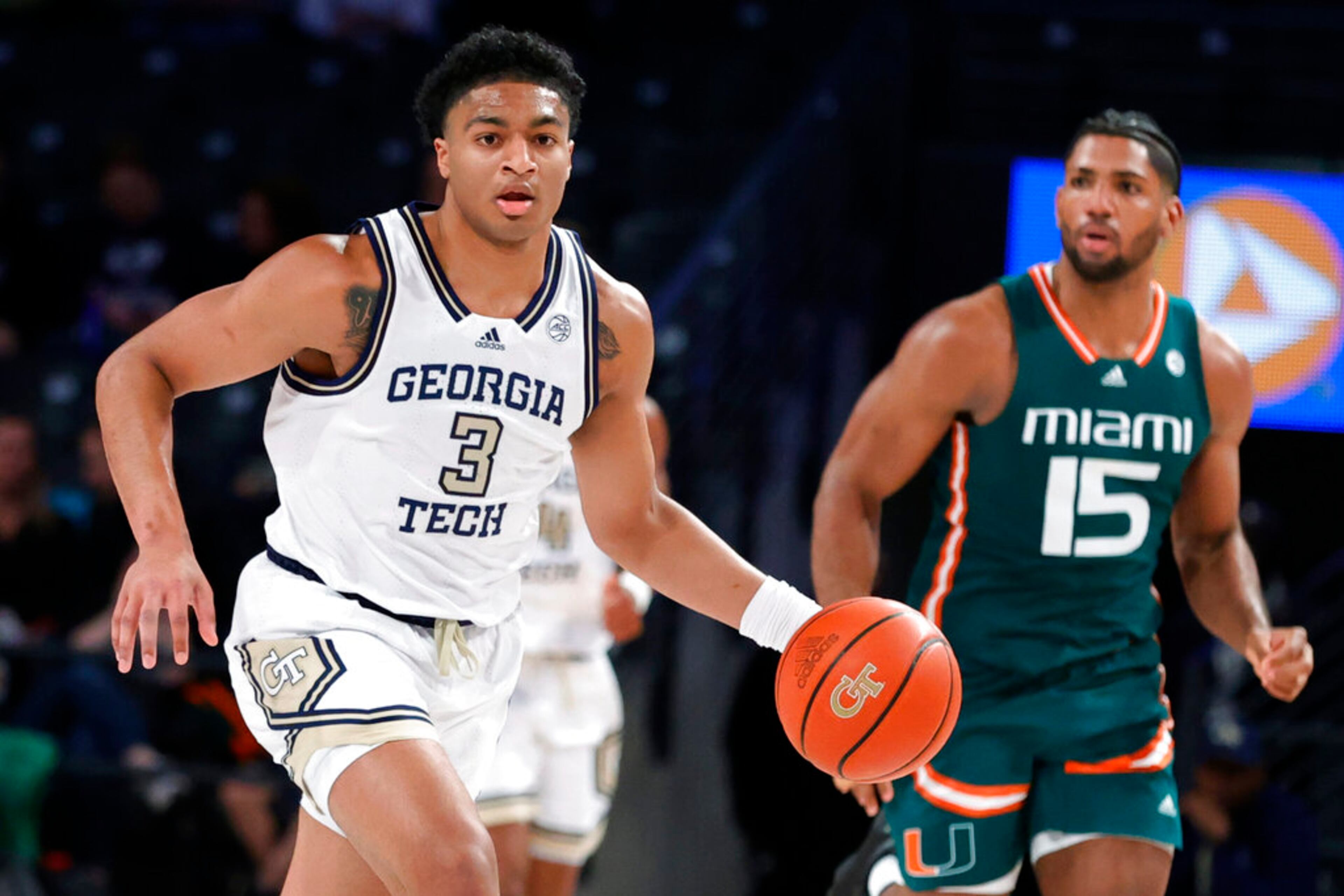 Georgia Tech guard Dallan Coleman, left, brings the ball up, followed by Miami forward Norchad Omier during the first half of an NCAA college basketball game Wednesday, Jan. 4, 2023, in Atlanta. (AP Photo/Alex Slitz)